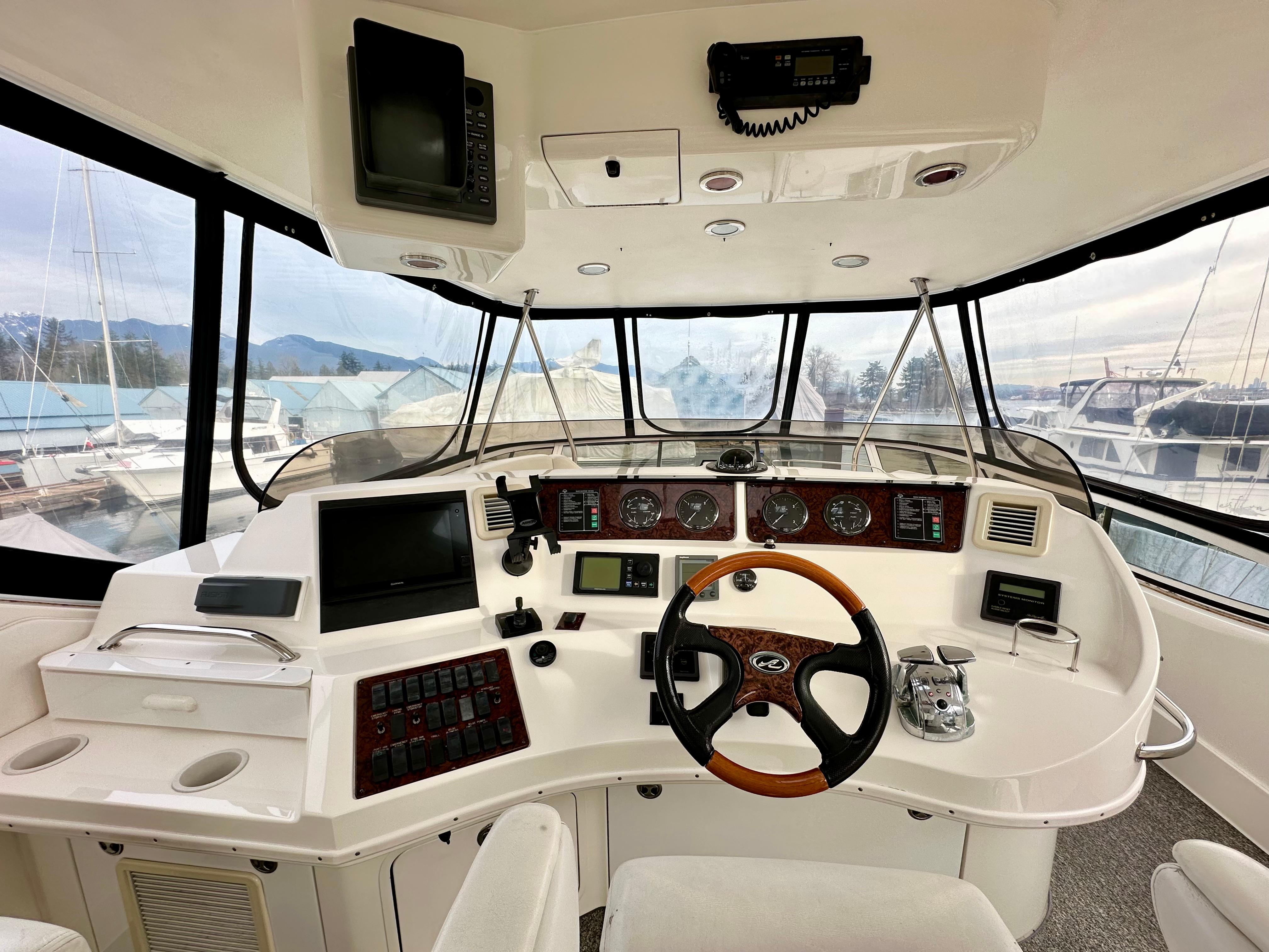 Cockpit of 2002 Sea Ray 560 Sedan Bridge with navigation equipment and steering wheel.