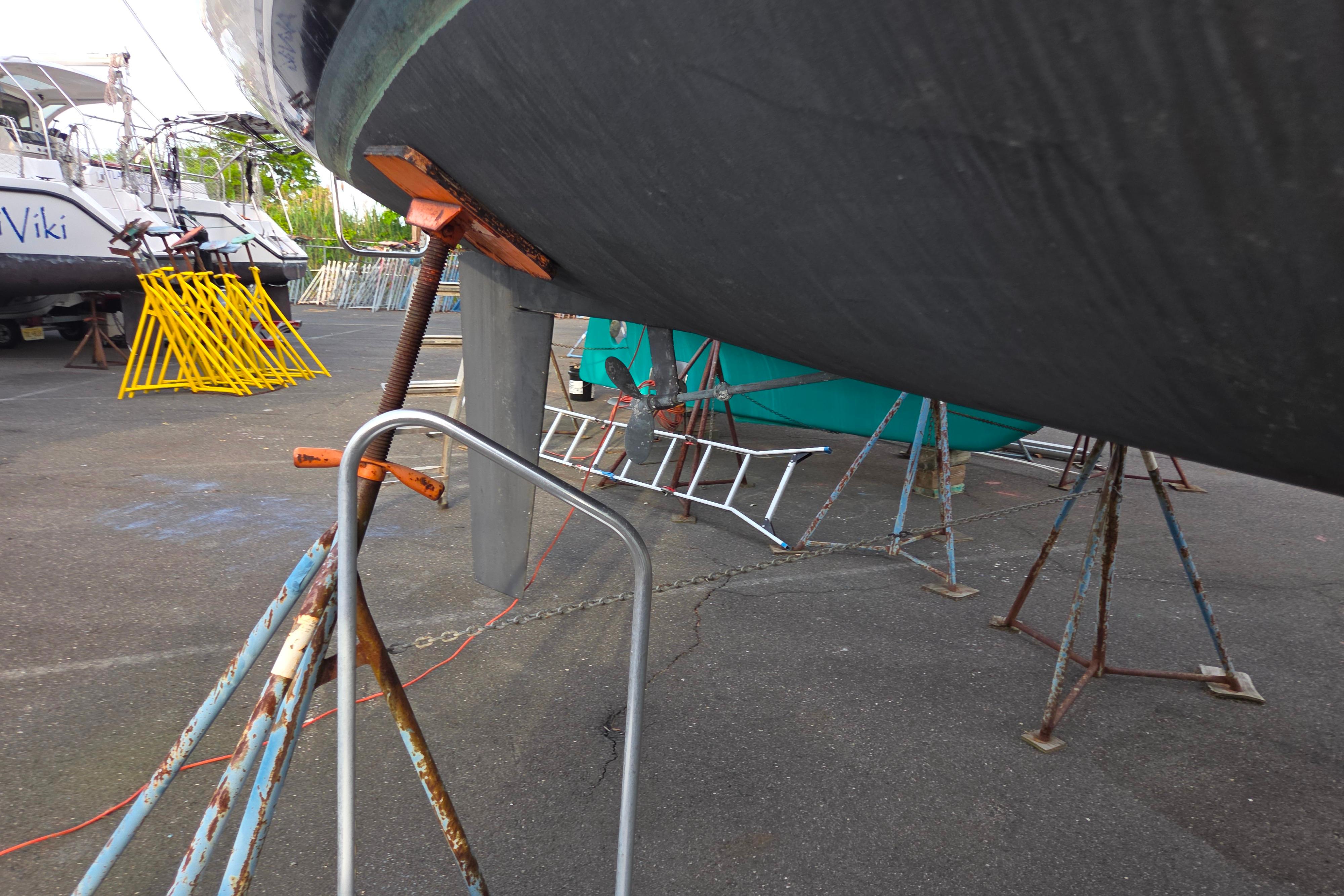 Catalina 355 sailboat from 1986 on stands in a boatyard.