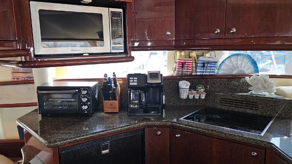 Modern kitchen in 2005 Neptunus 56 Flybridge yacht with appliances and granite countertops.