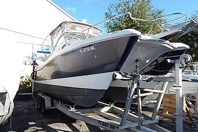 2003 World Cat 270 EC boat on trailer, parked outdoors.