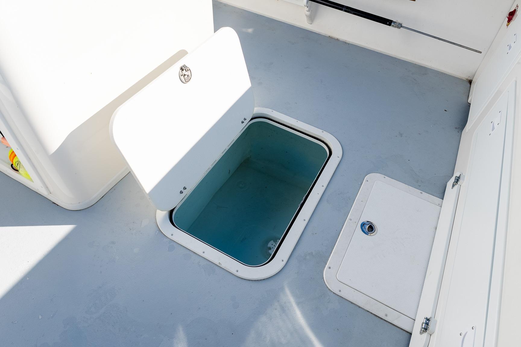 Open hatch on 2024 Steiger Craft 31 Fisherman boat deck, showcasing storage space.