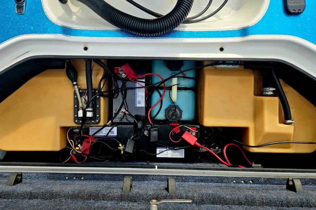 1996 Champion 181 SX boat battery compartment with wiring and fuel tanks.