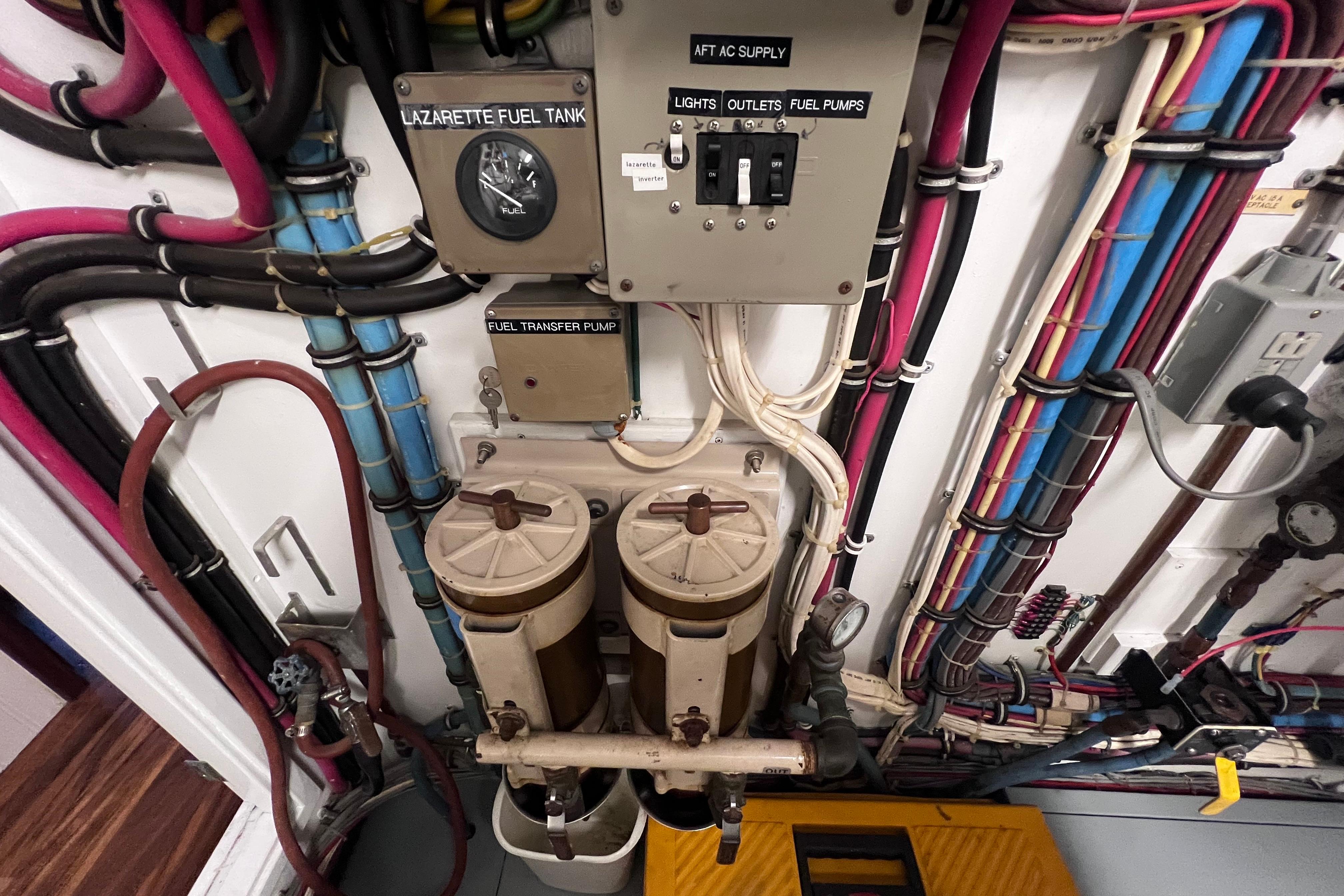 Engine room of 1987 Hatteras 70 Cockpit Motor Yacht with fuel system components and wiring.