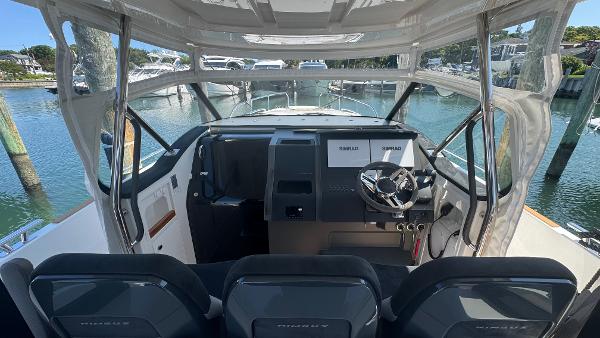 Interior view of 2025 Nimbus T11 boat cockpit with modern steering and controls.