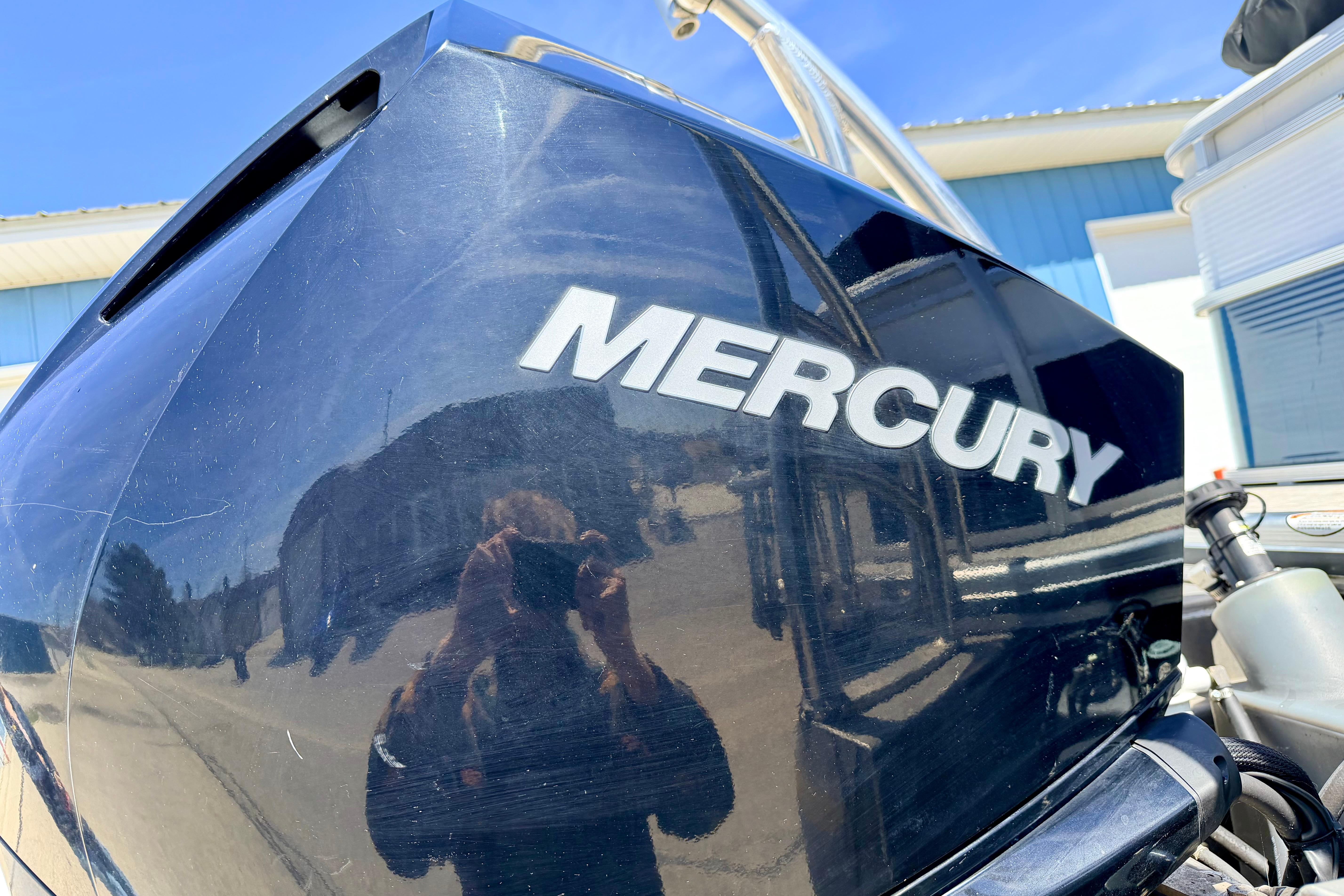 Mercury outboard motor on 2019 Crestliner 240 Rally DX CW boat, reflecting surroundings.