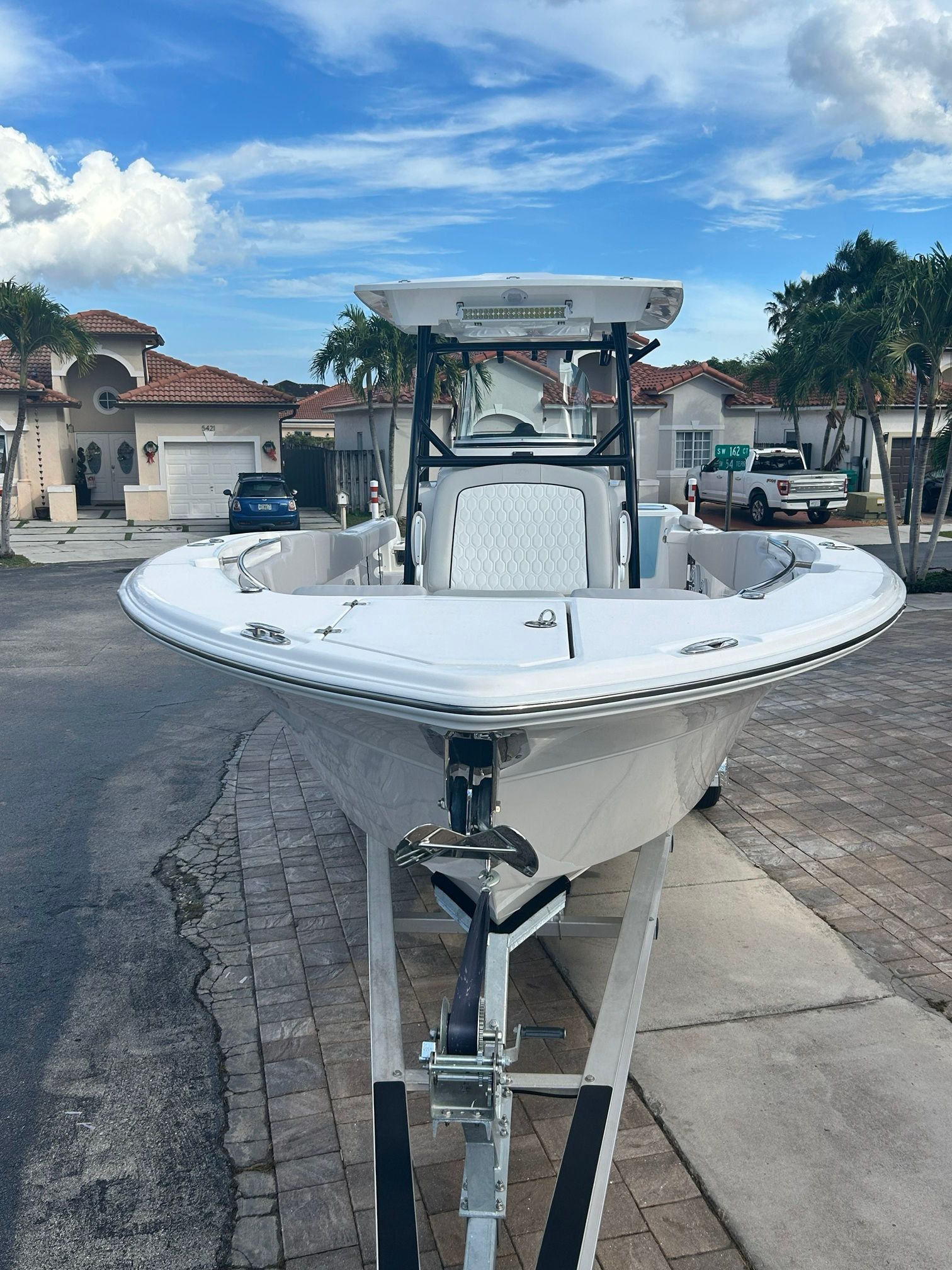 A 2023 Sea Fox 288 Commander on a trailer in a residential area.