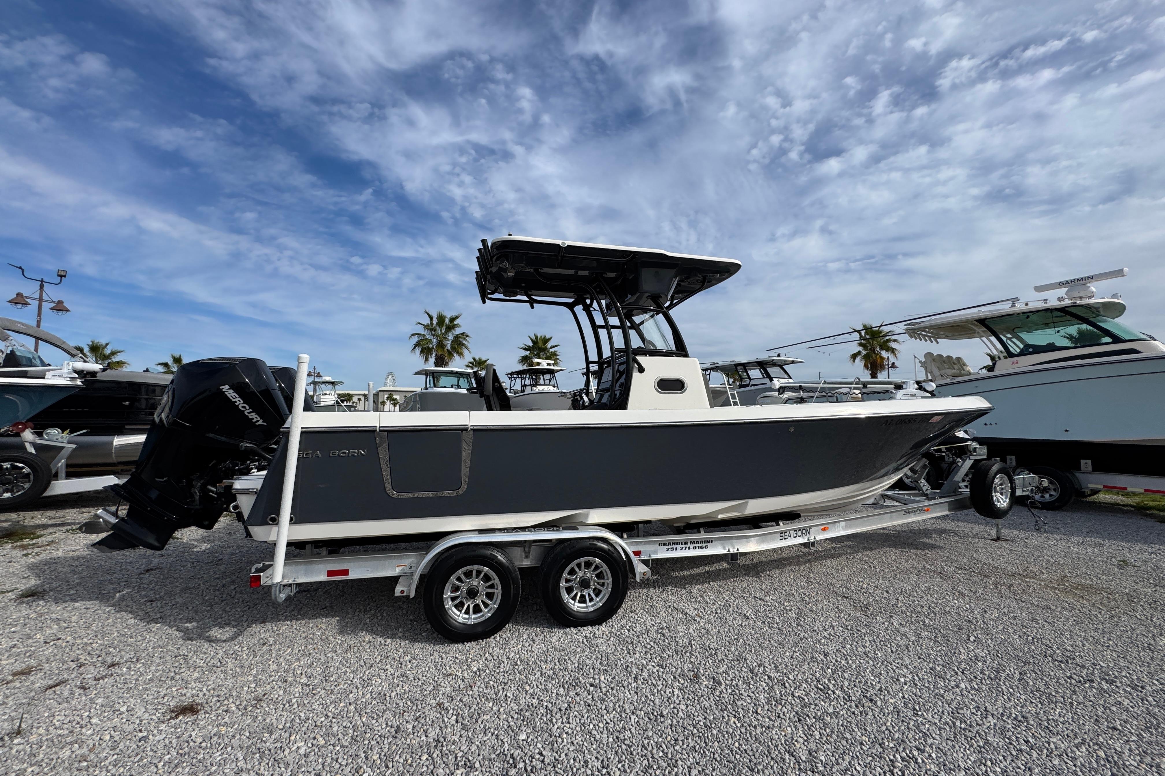 2021 Sea Born LX26 Center Console boat on trailer, parked outdoors under a cloudy sky.