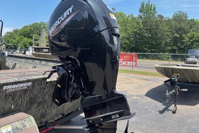 2026 Tracker Grizzly 2072 CC boat with Mercury outboard motor in a sunny outdoor setting.