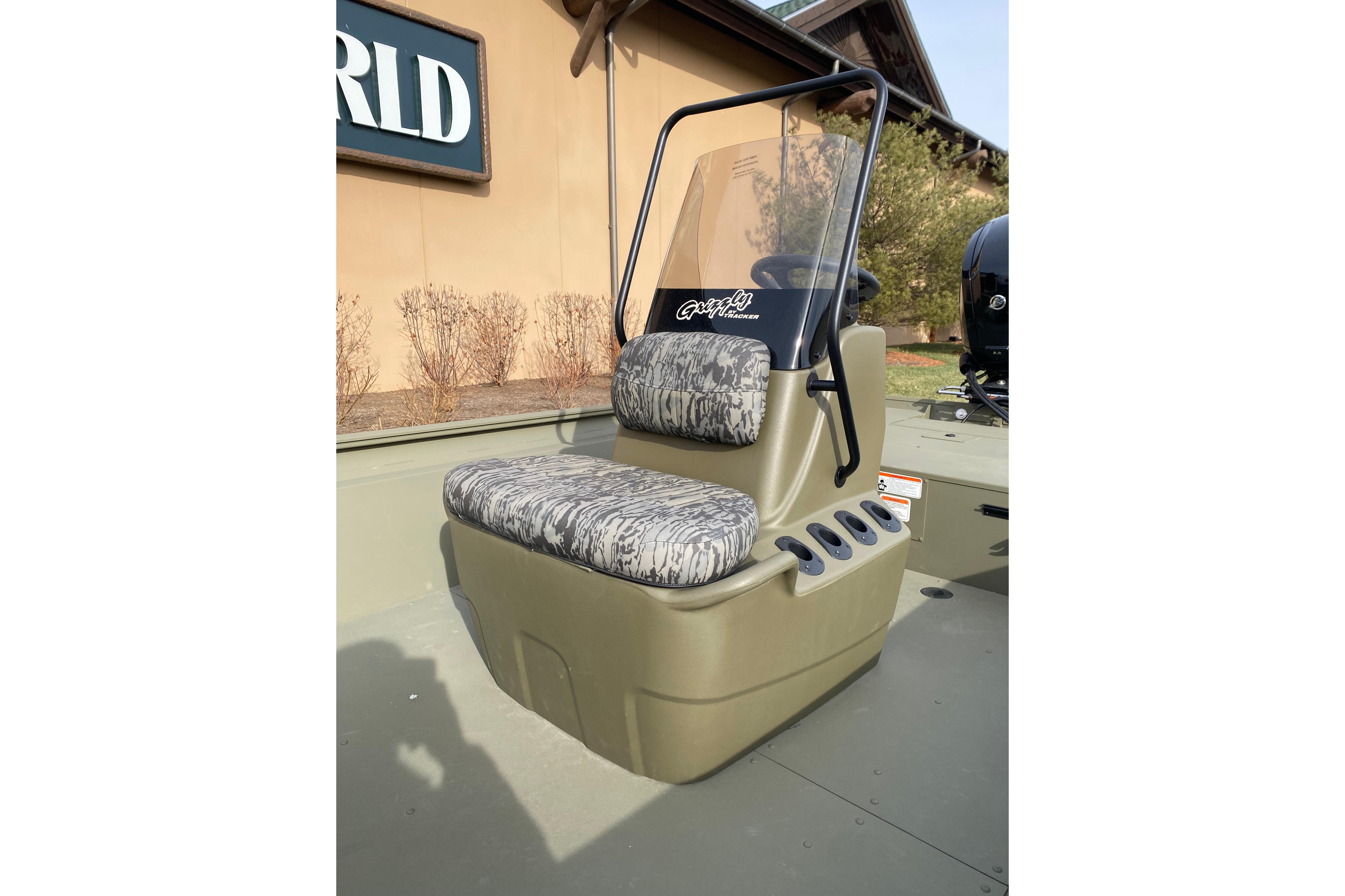 2026 Tracker Grizzly 1860 CC boat seat with camouflage pattern and windshield.
