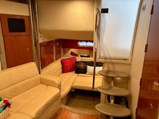 Interior of the 2007 Formula 34 Performance Cruiser with beige sofas and a staircase.