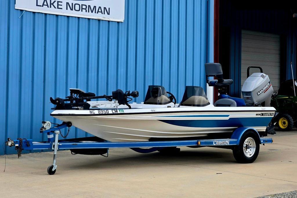 1996 Champion 181 SX boat on trailer, parked outside blue building at Lake Norman.