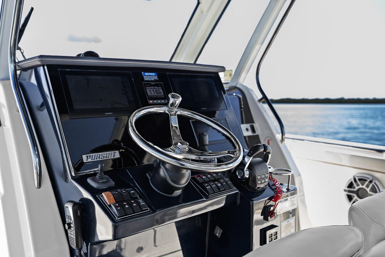 2021 Pursuit S 328 Sport boat helm with steering wheel and controls.