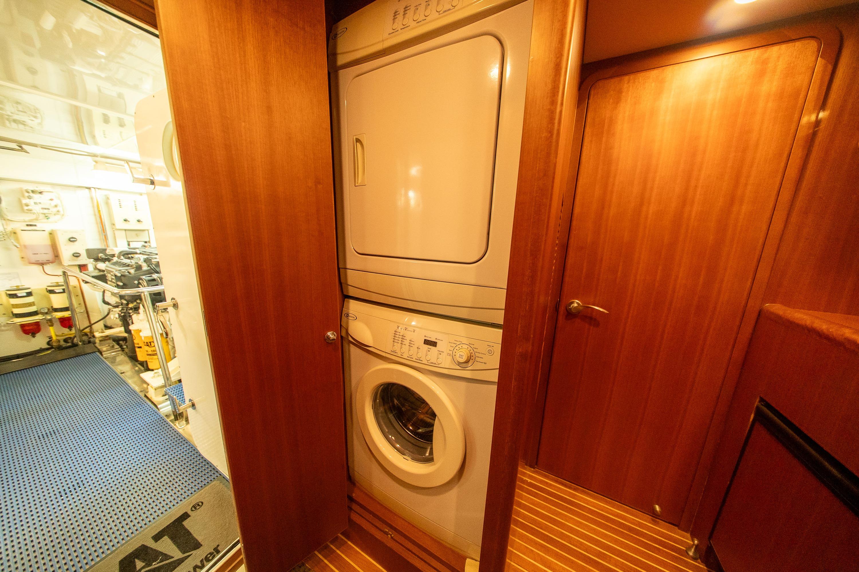 Laundry area in 2007 Ocean Alexander 74 Pilothouse yacht with stacked washer and dryer.