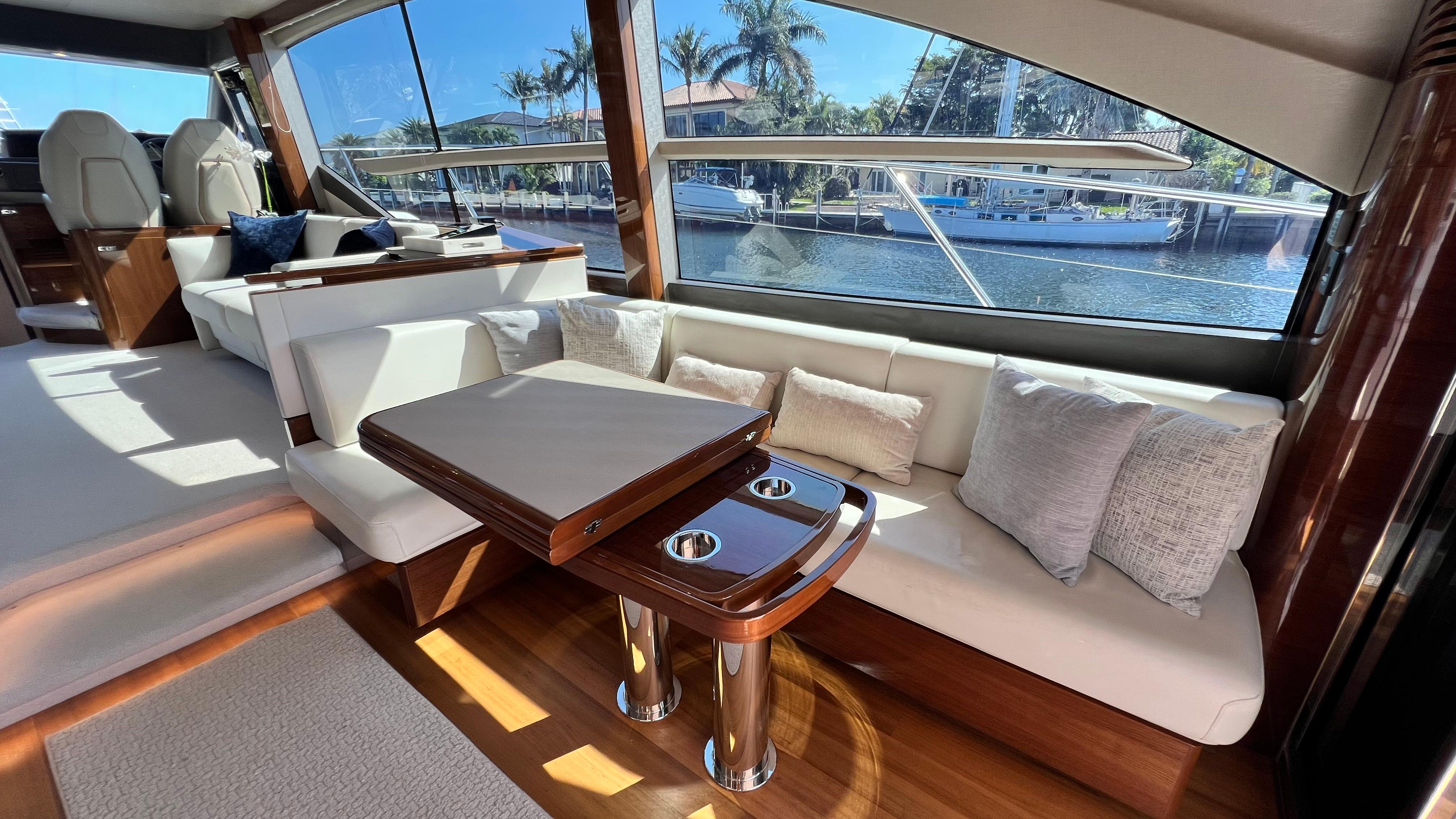 Luxurious 2019 Princess F62 yacht interior with elegant seating and waterfront view.