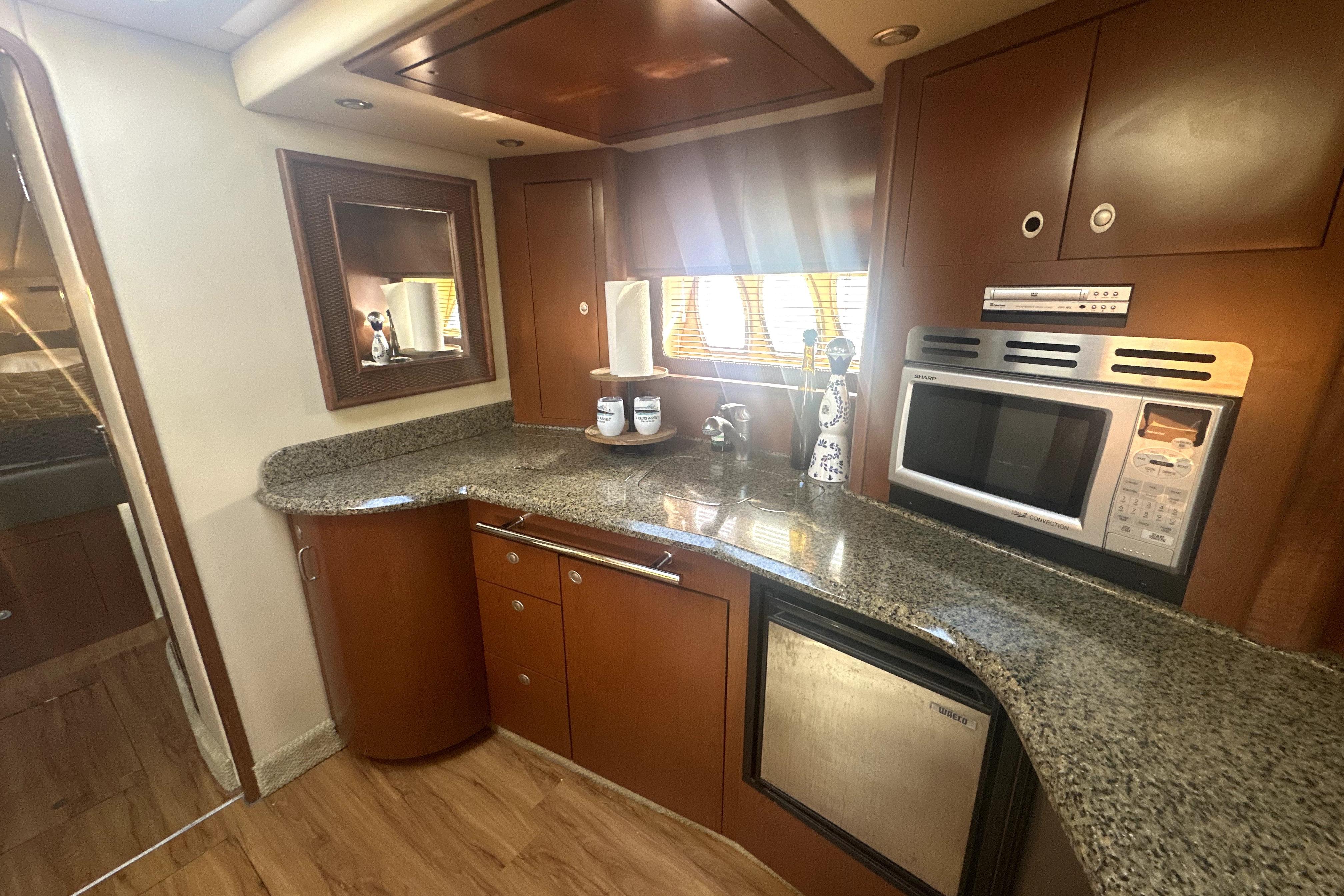 Luxurious 2007 Sea Ray 44 Sundancer yacht kitchen with granite countertops and modern appliances.