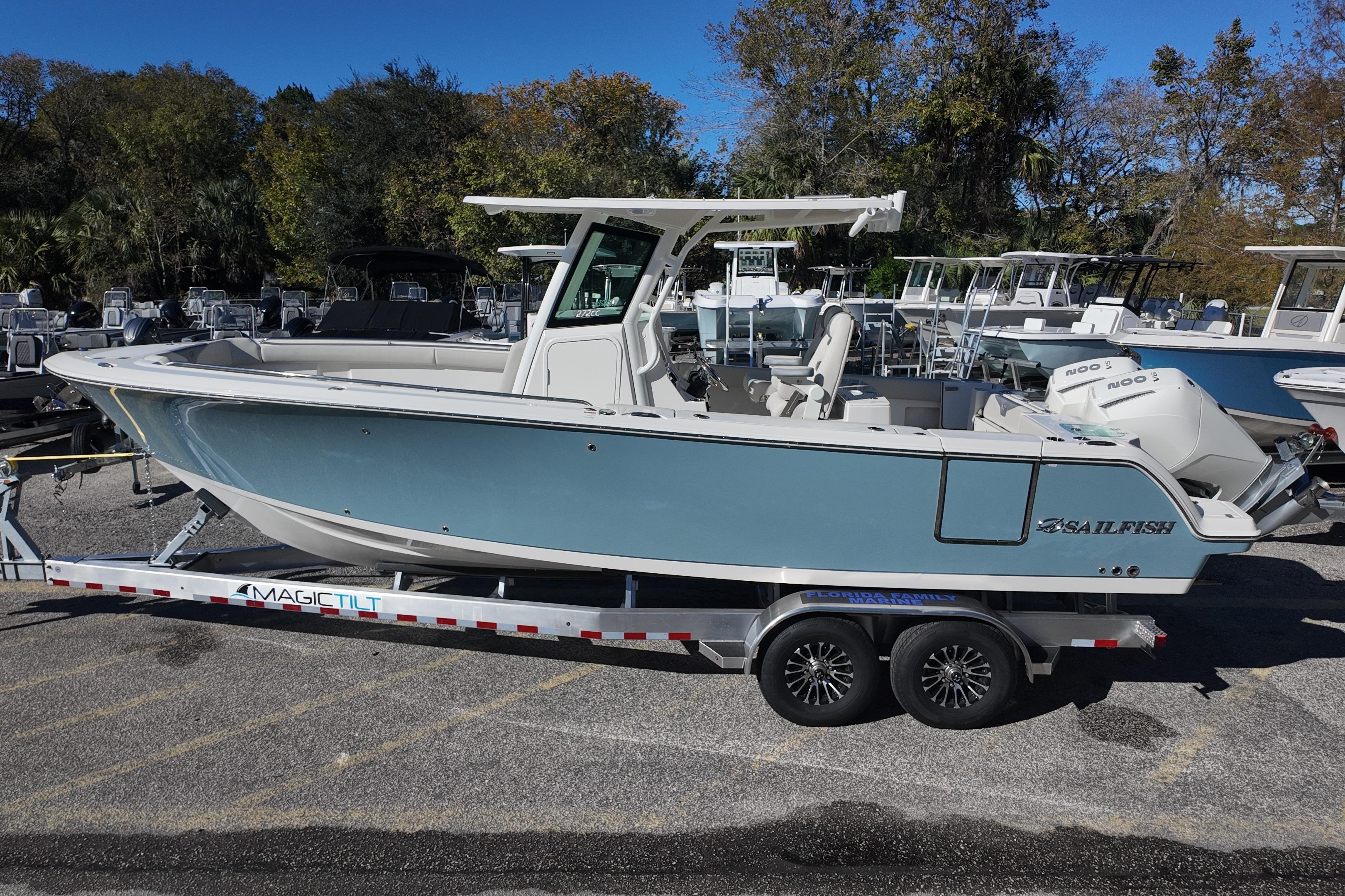 2026 Sailfish 272 CC boat on trailer, parked outdoors with trees in background.