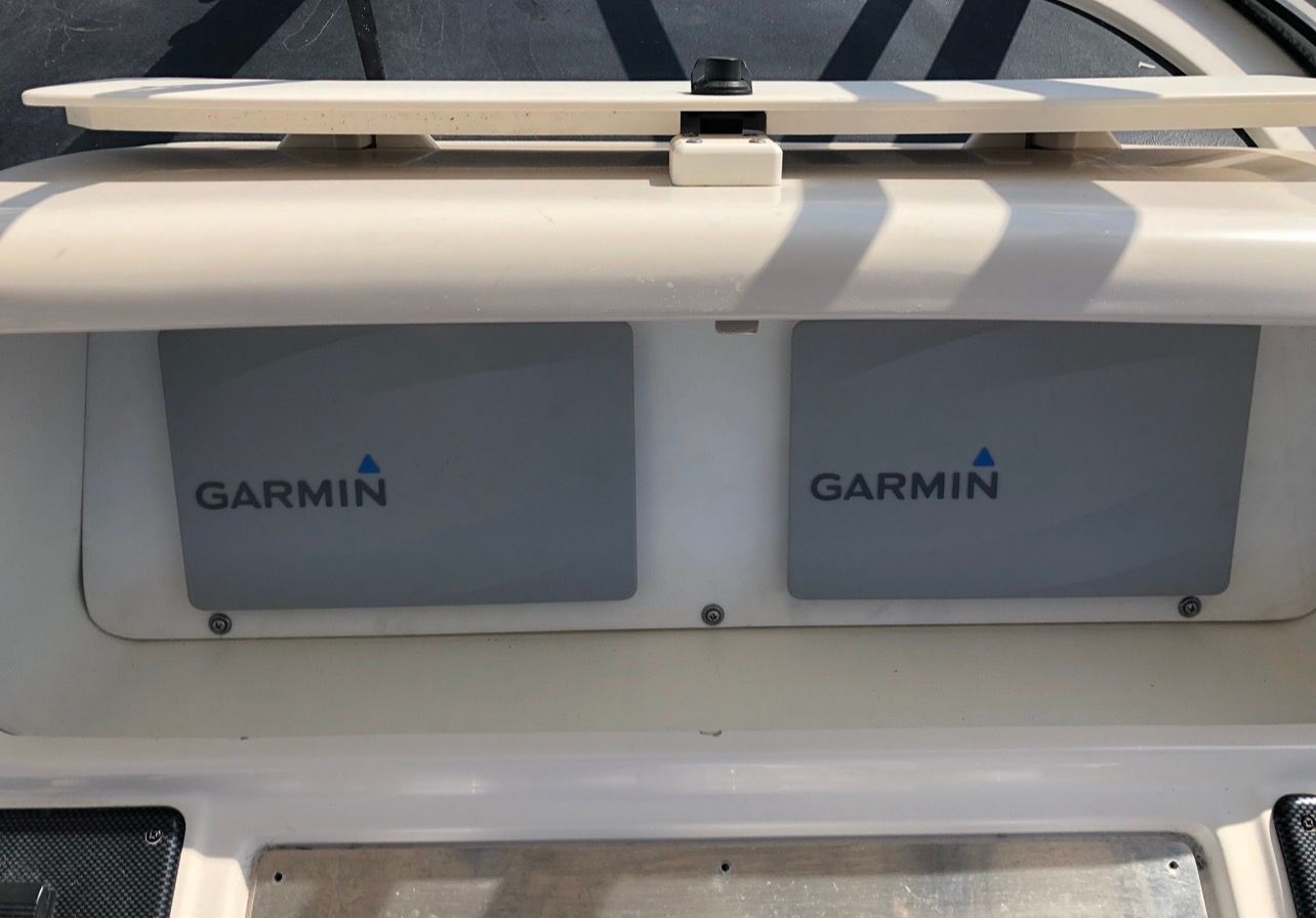 Garmin devices mounted on a boat panel.