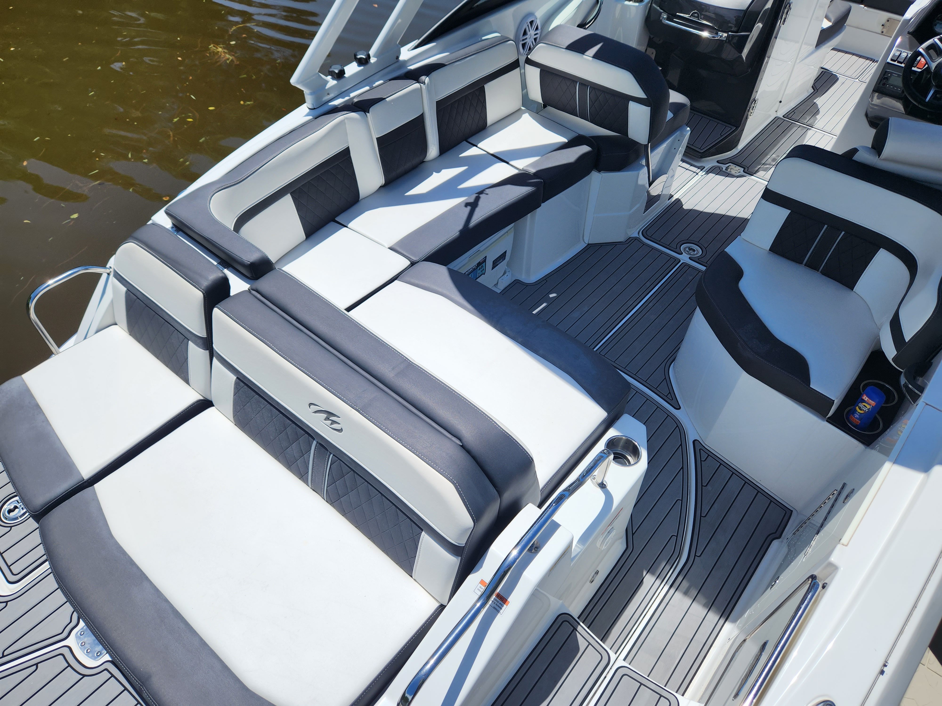 The image shows the spacious cockpit of a 2021 Monterey M6 boat with sleek seating.
