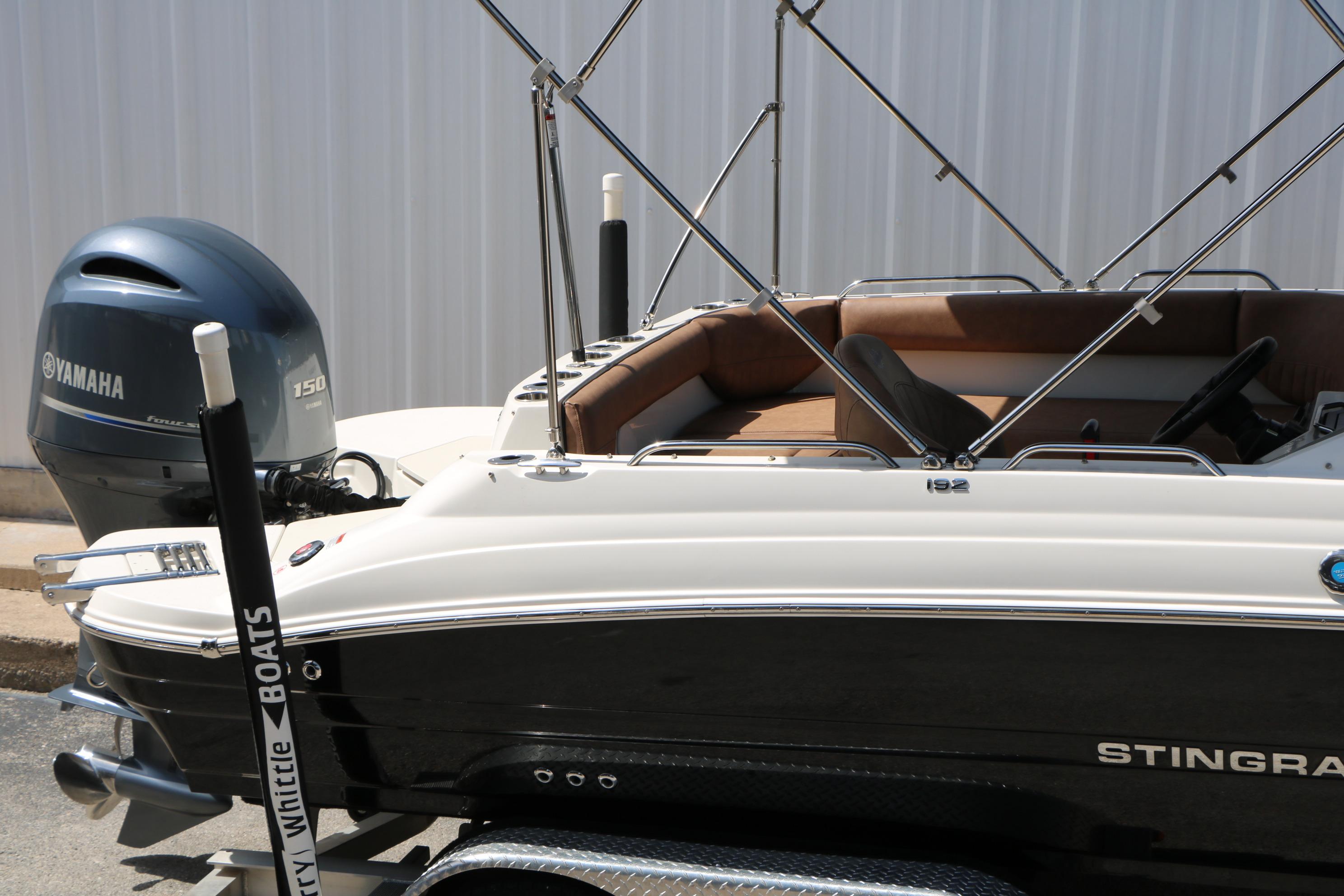 2022 Stingray 192 SC boat with Yamaha 150 engine, parked on a trailer.