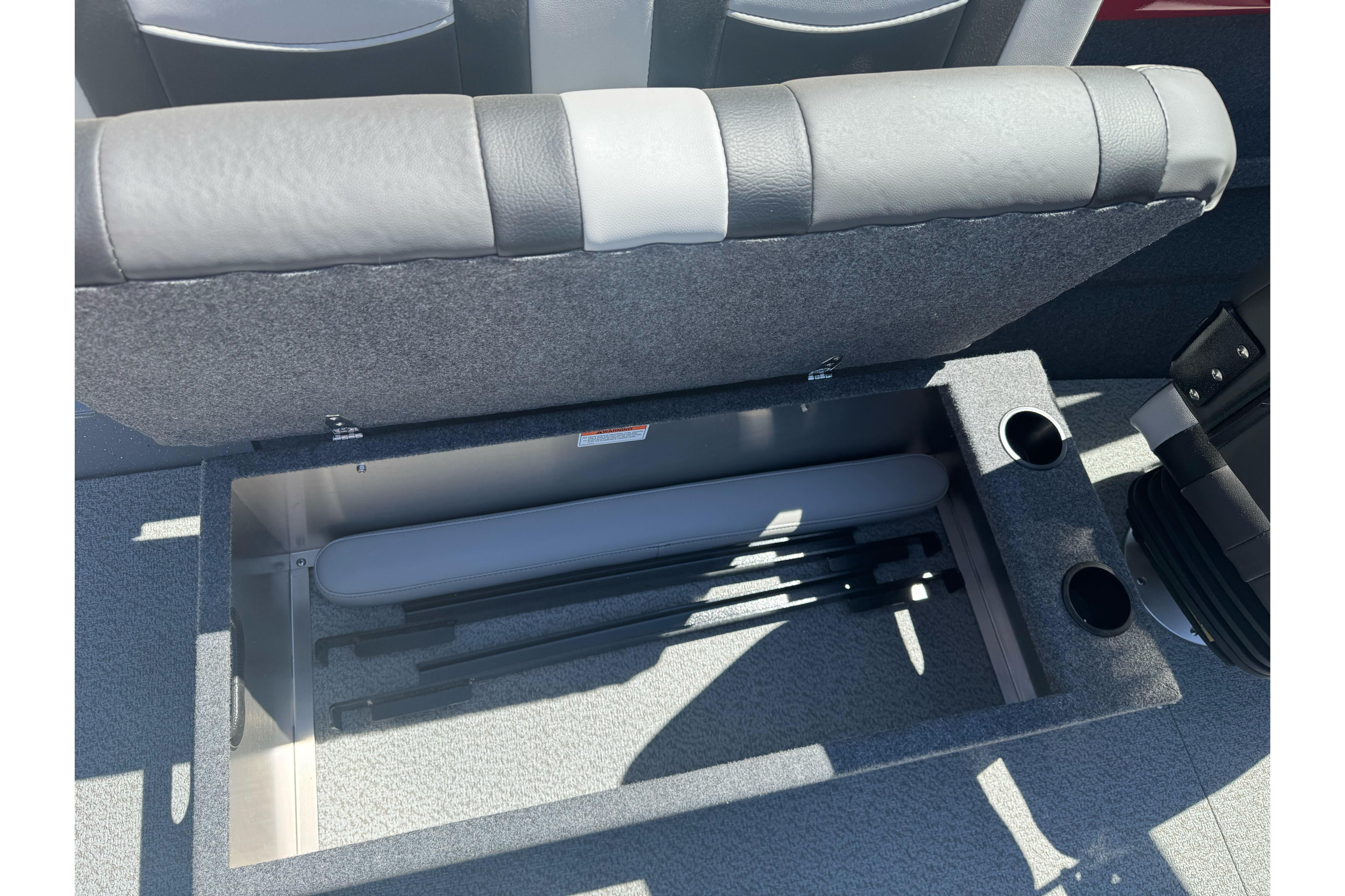 Open storage compartment in 2026 Lund 210 Heavy Gauge boat with cup holders.