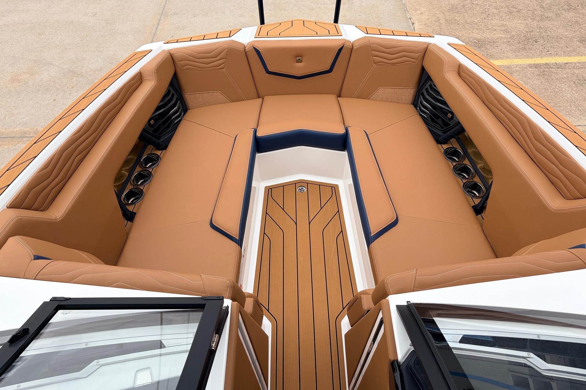 2026 Nautique Super Air Nautique G25 boat interior with tan seating and cup holders.