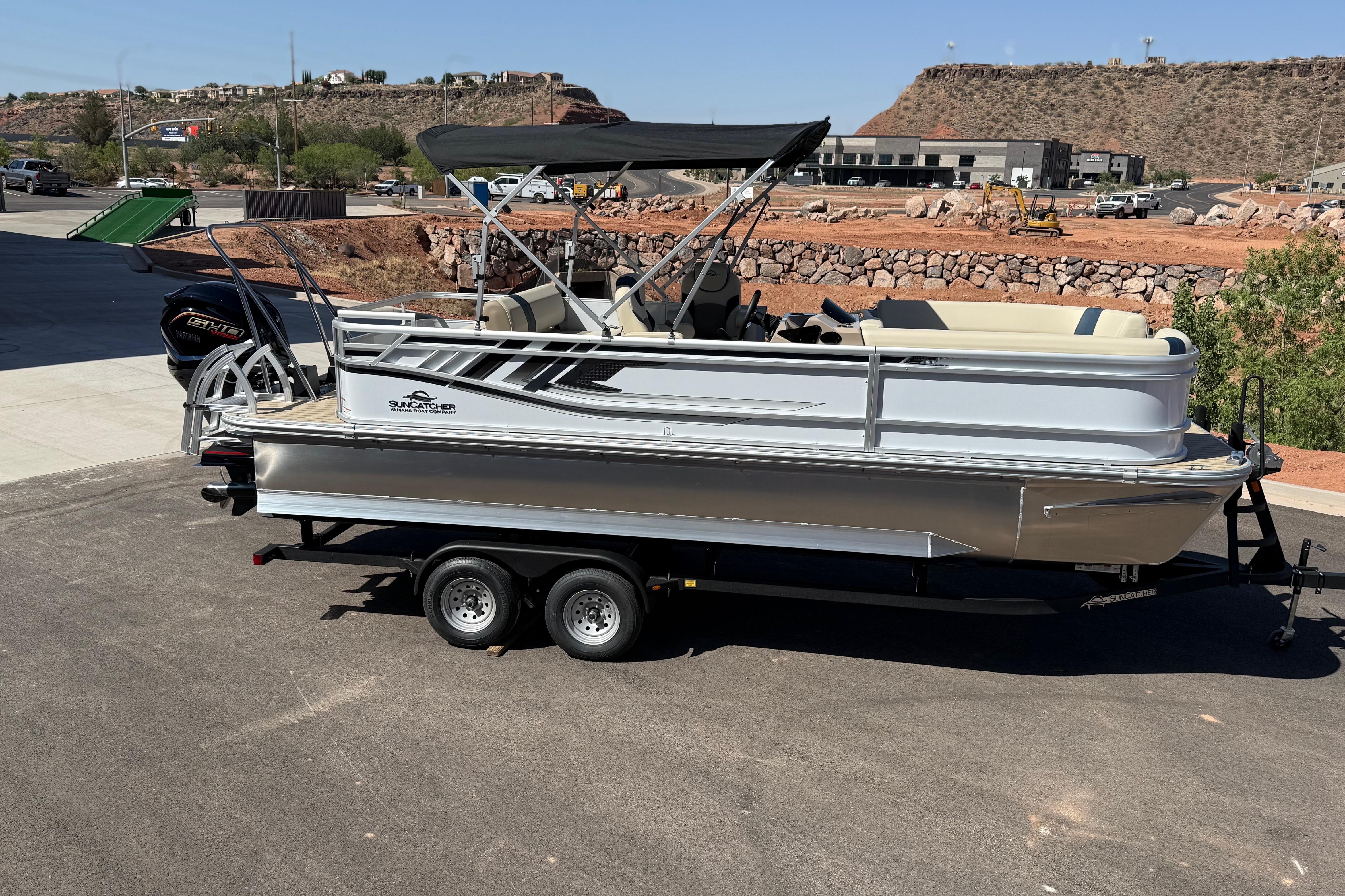 2026 SunCatcher Select 322SL pontoon boat on trailer, parked outdoors.