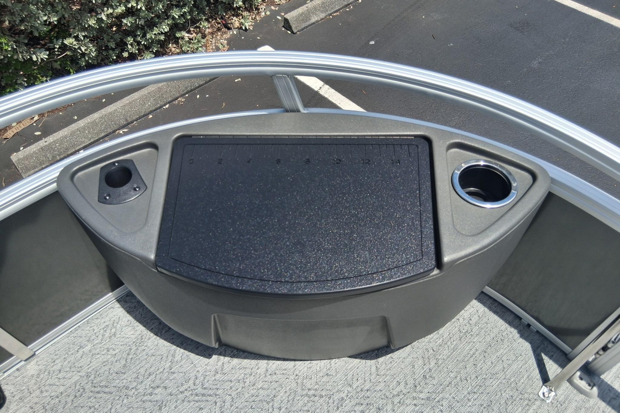 2026 Sun Tracker Bass Buggy 18 DLX boat console with cup holders and ruler.
