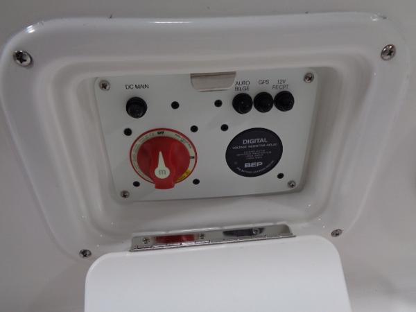 Control panel of 2023 Robalo 246 Cayman with switches and dial.