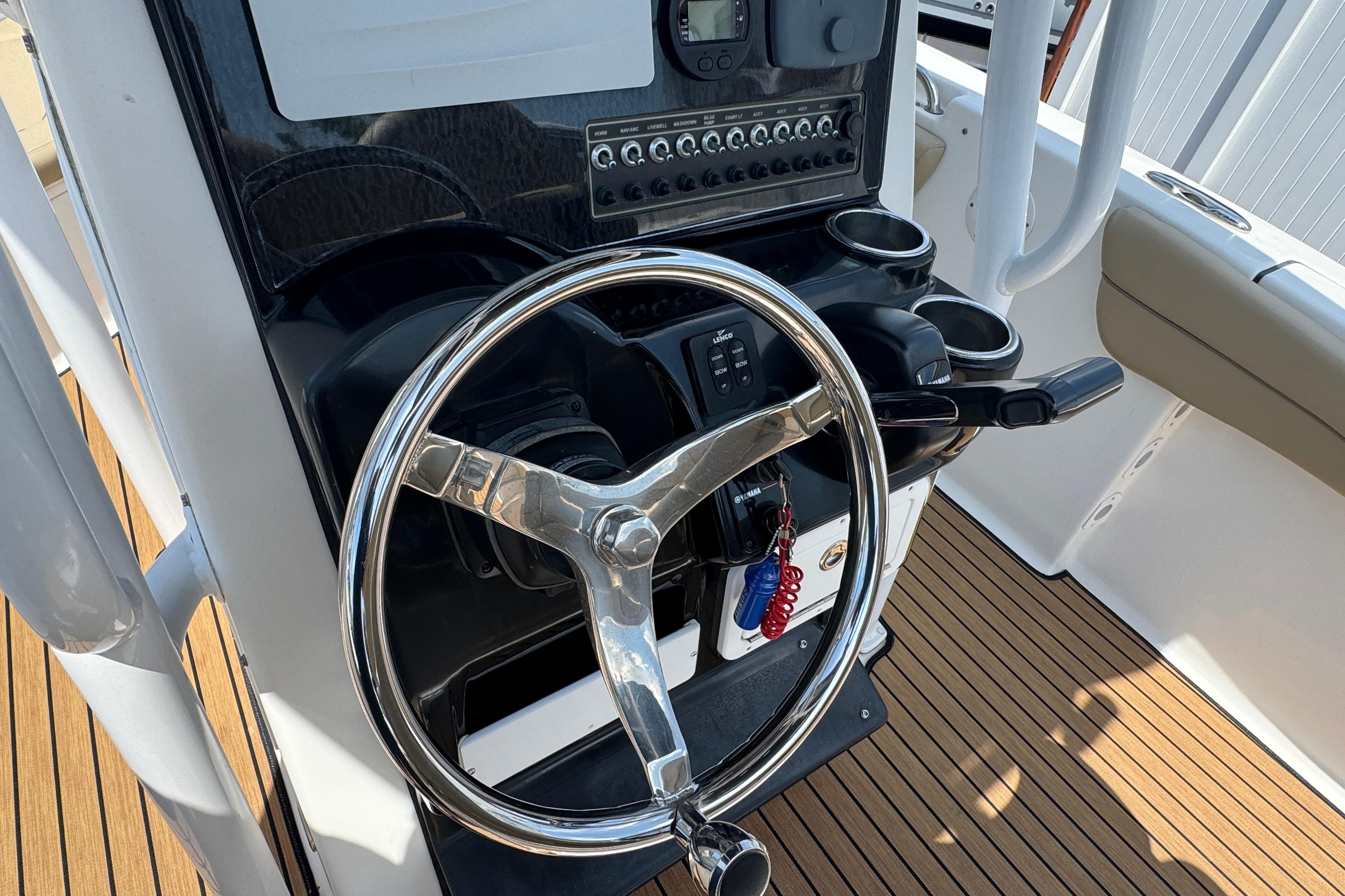 Steering console of a 2016 Tidewater 230 LXF boat with modern controls.