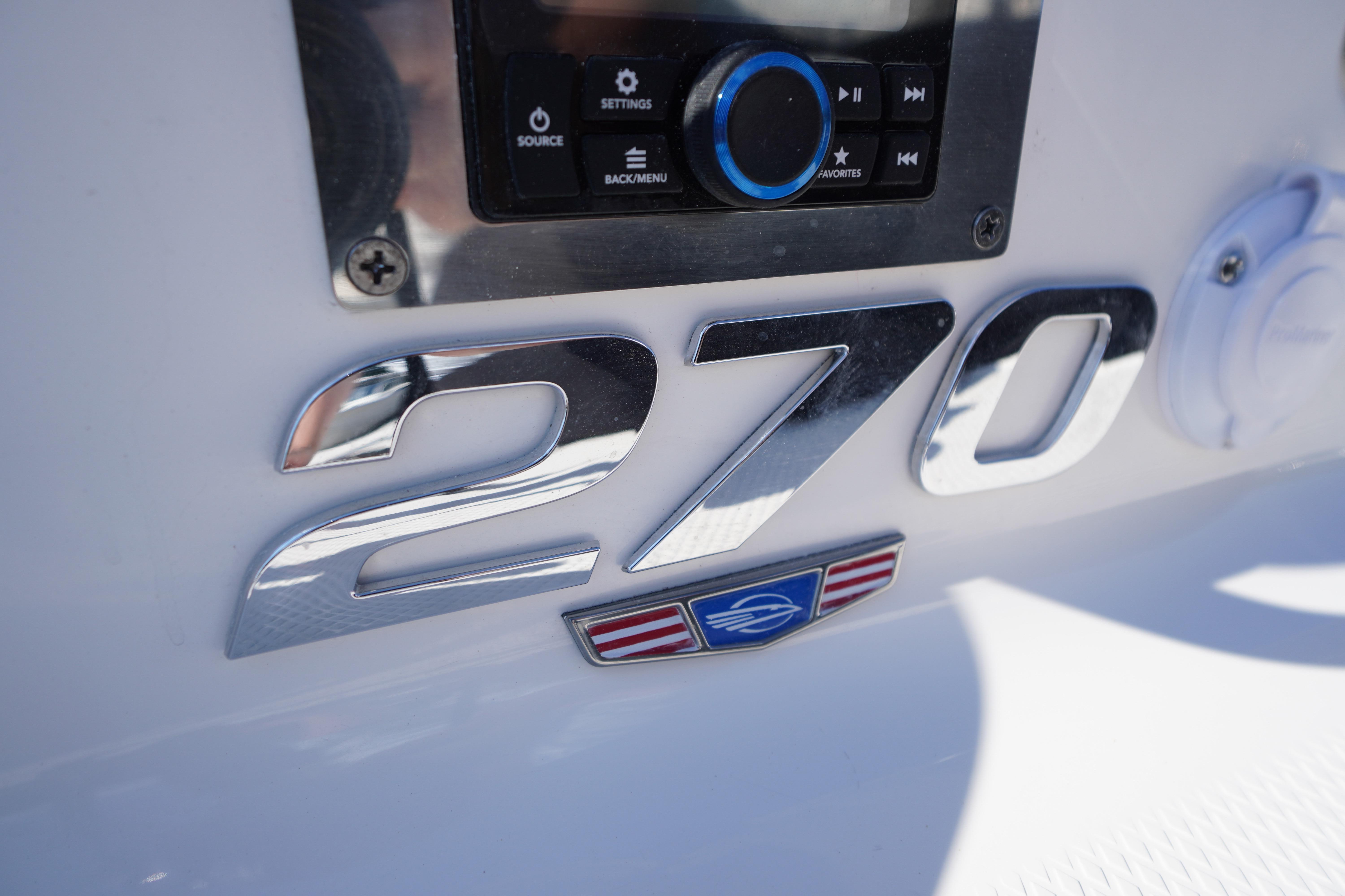 2026 Chaparral 270 OSX boat dashboard with chrome model emblem and control panel.