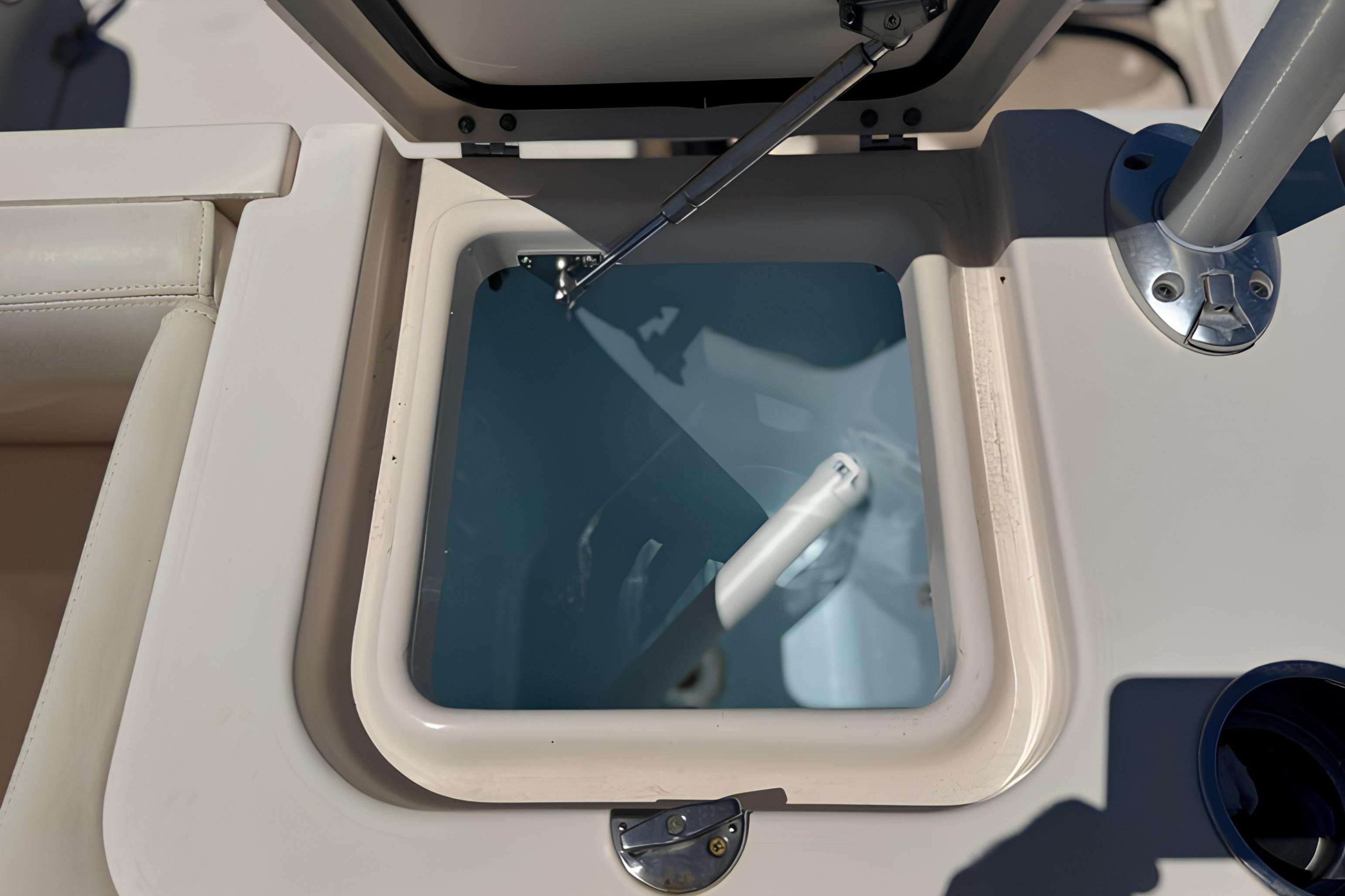 Open hatch on 2017 Grady-White Freedom 235 boat, showing interior compartment.