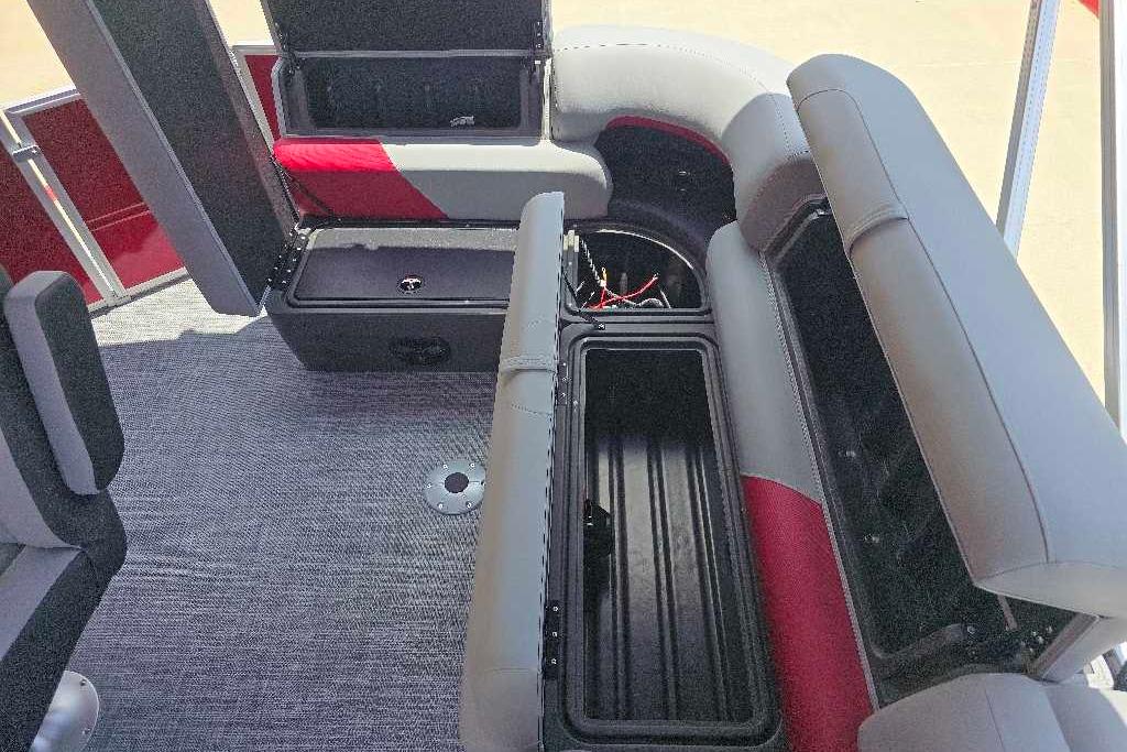 2026 Sun Tracker Party Barge 20 DLX interior with open storage compartments and seating.