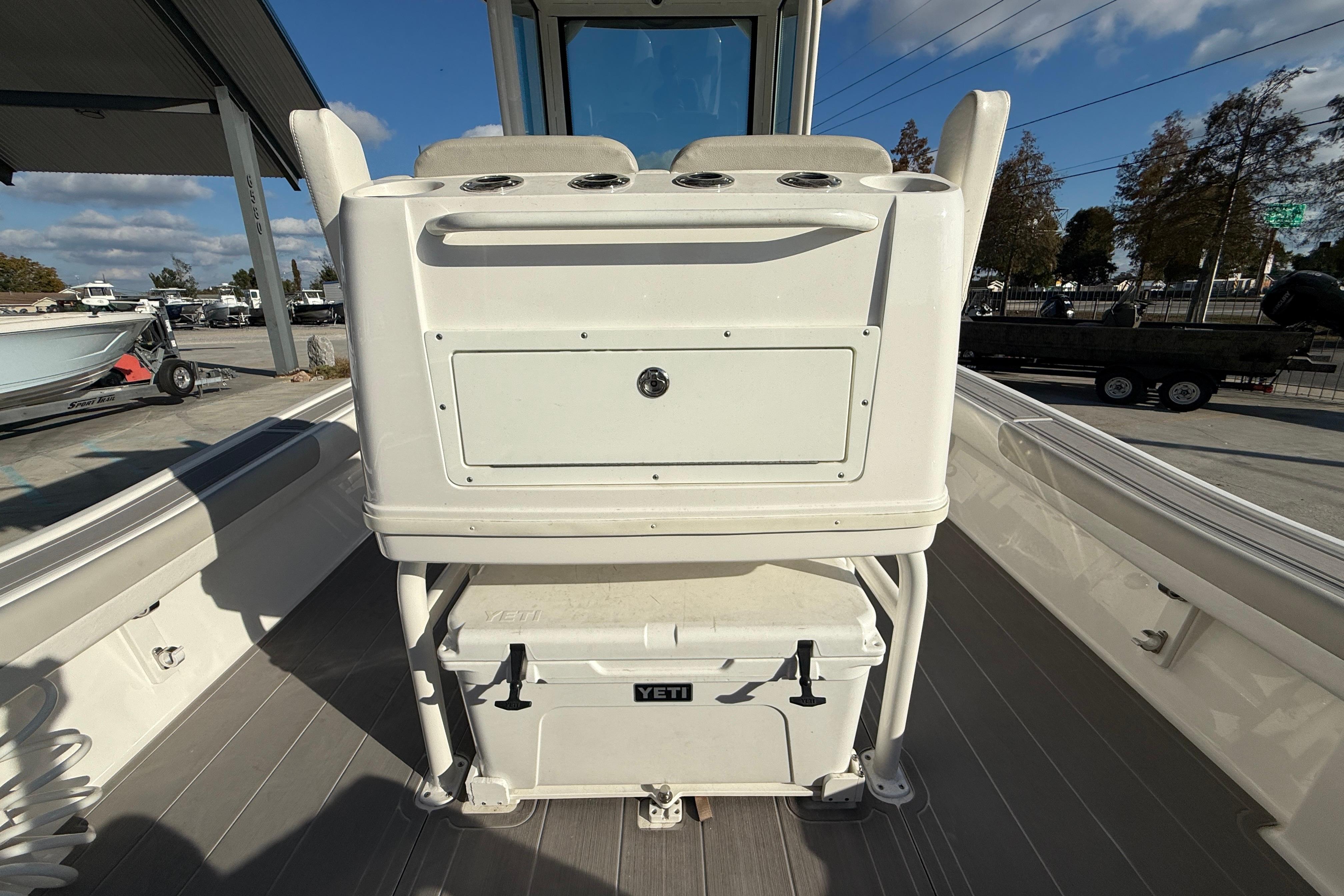 2022 Caymas 28 HB Twin boat interior with Yeti cooler and storage compartment.