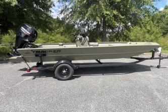 2026 Tracker Grizzly 1860 CC boat on trailer, parked outdoors.