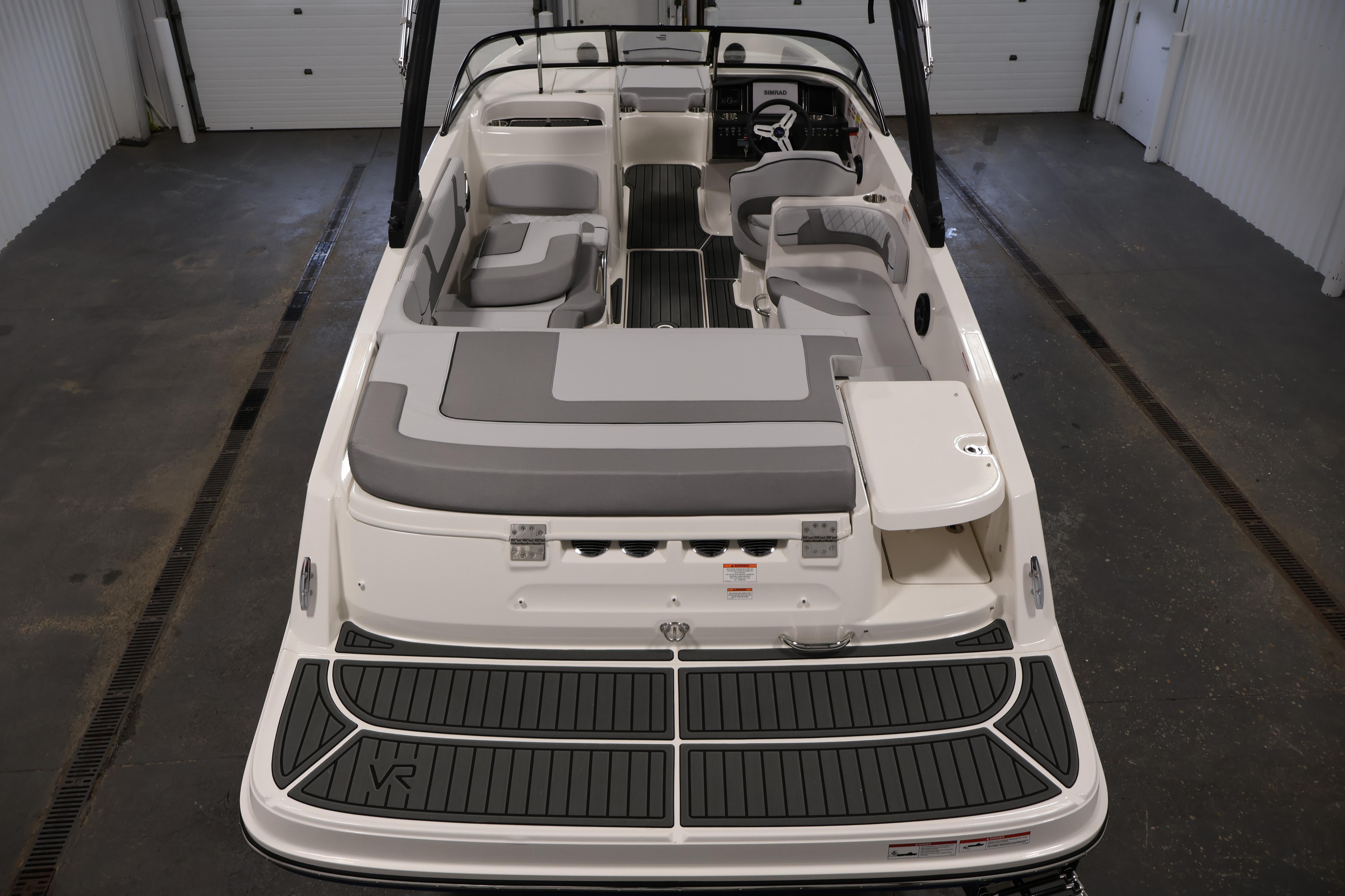2026 Bayliner VR6 Bowrider I/O with spacious seating and sleek design in a showroom.