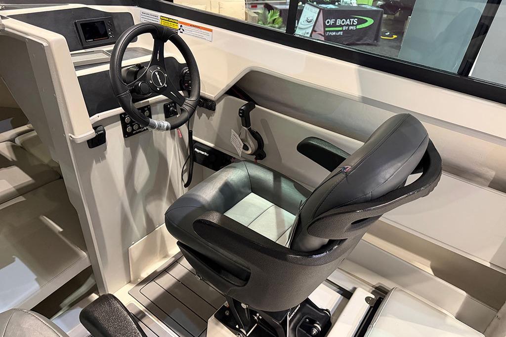 Interior view of 2027 Arima Sea Ranger 21 Hardtop boat cockpit with steering wheel and seat.