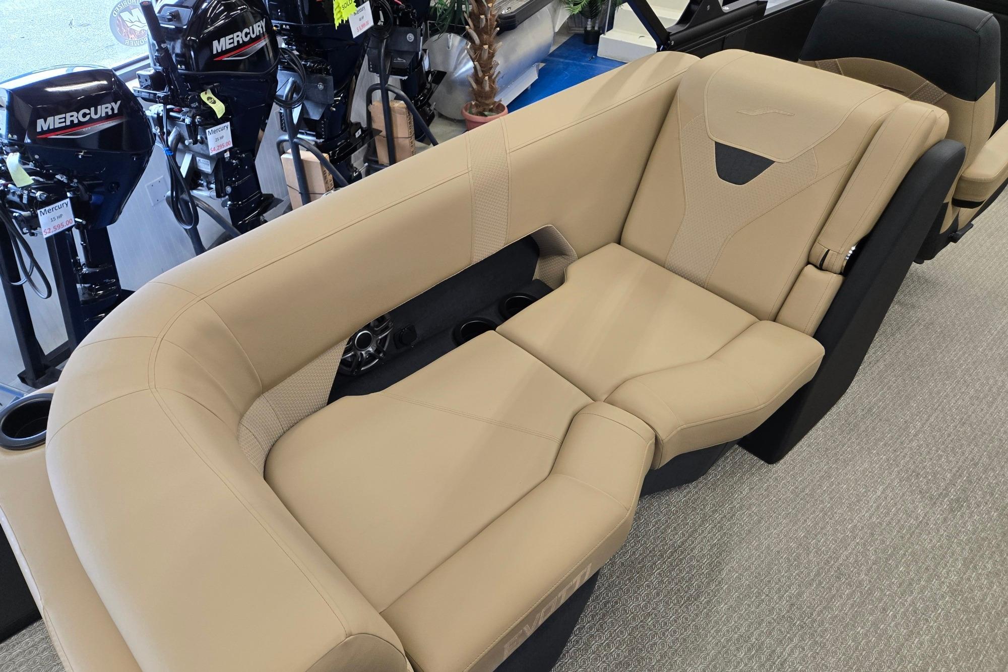 Luxurious beige seating in a 2026 Evotti 521QL boat, with Mercury outboard motors in the background.