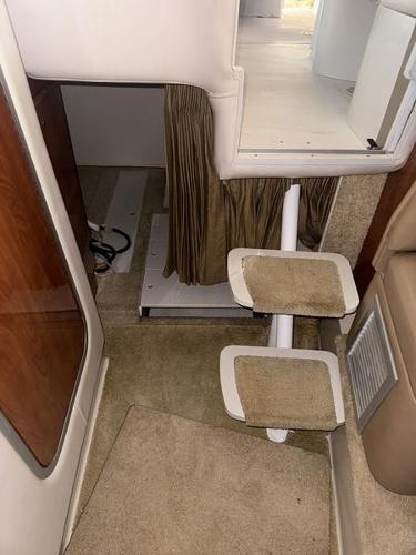 Interior of 2005 Four Winns 298 Vista boat with carpeted steps and wooden accents.