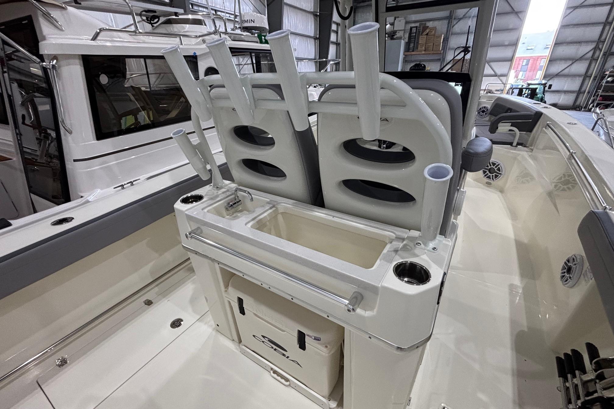 2026 Cobia 285 Open Center Console boat interior with rod holders and storage compartments.