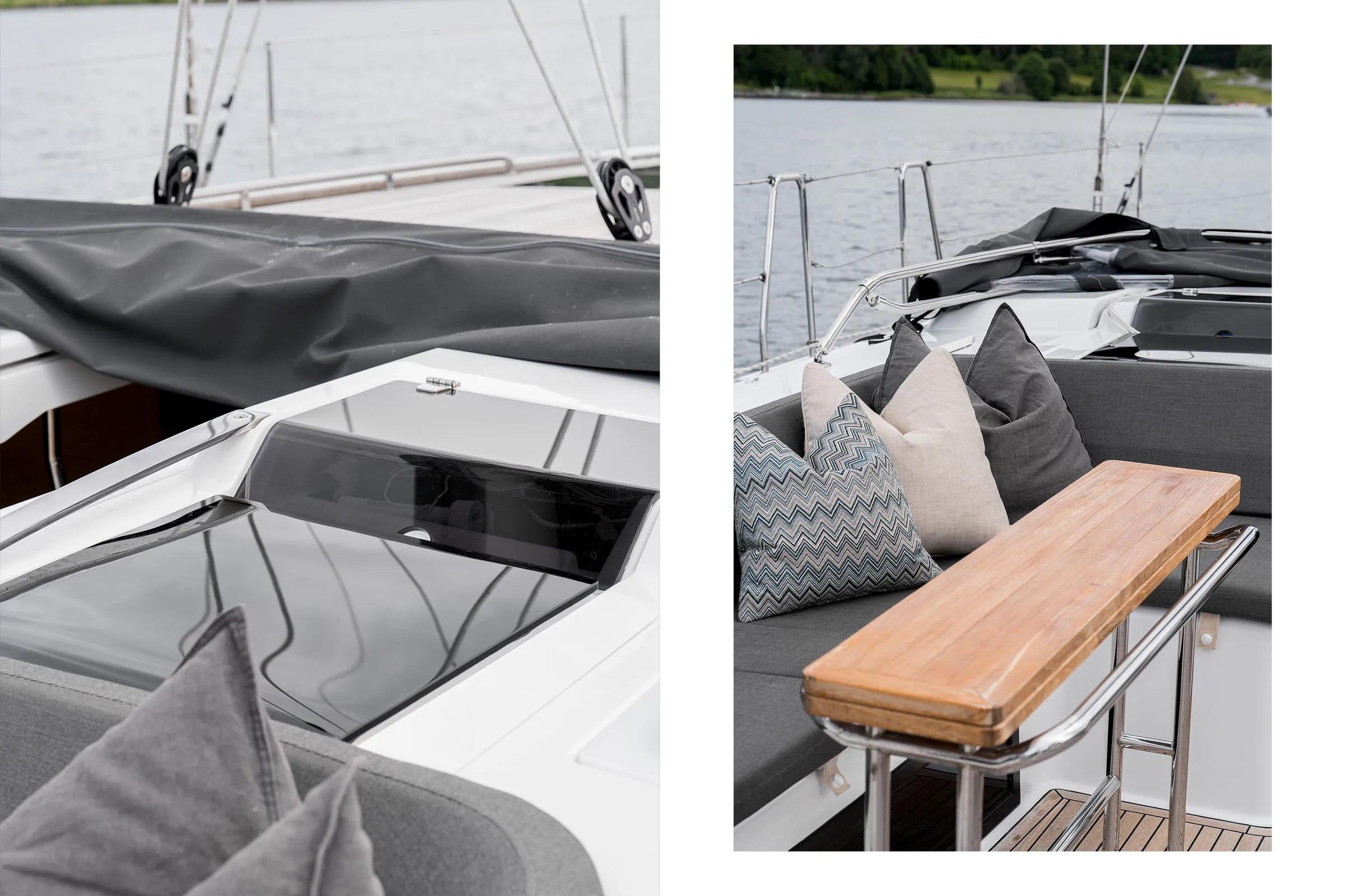 Luxurious 2019 Hanse 548 yacht interior with stylish cushions and sleek wooden table.