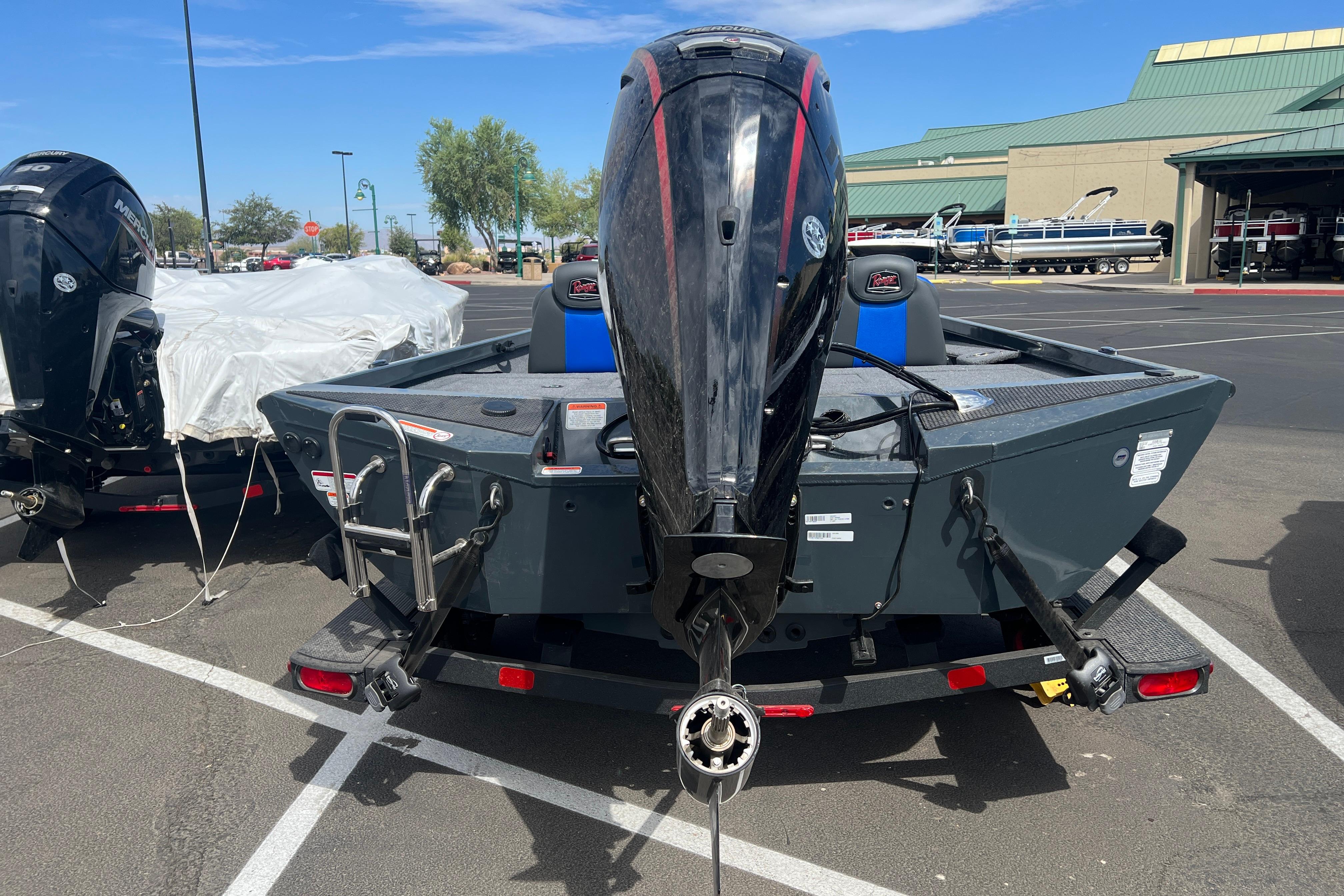 2026 Ranger RT188P boat with outboard motor in a parking lot.