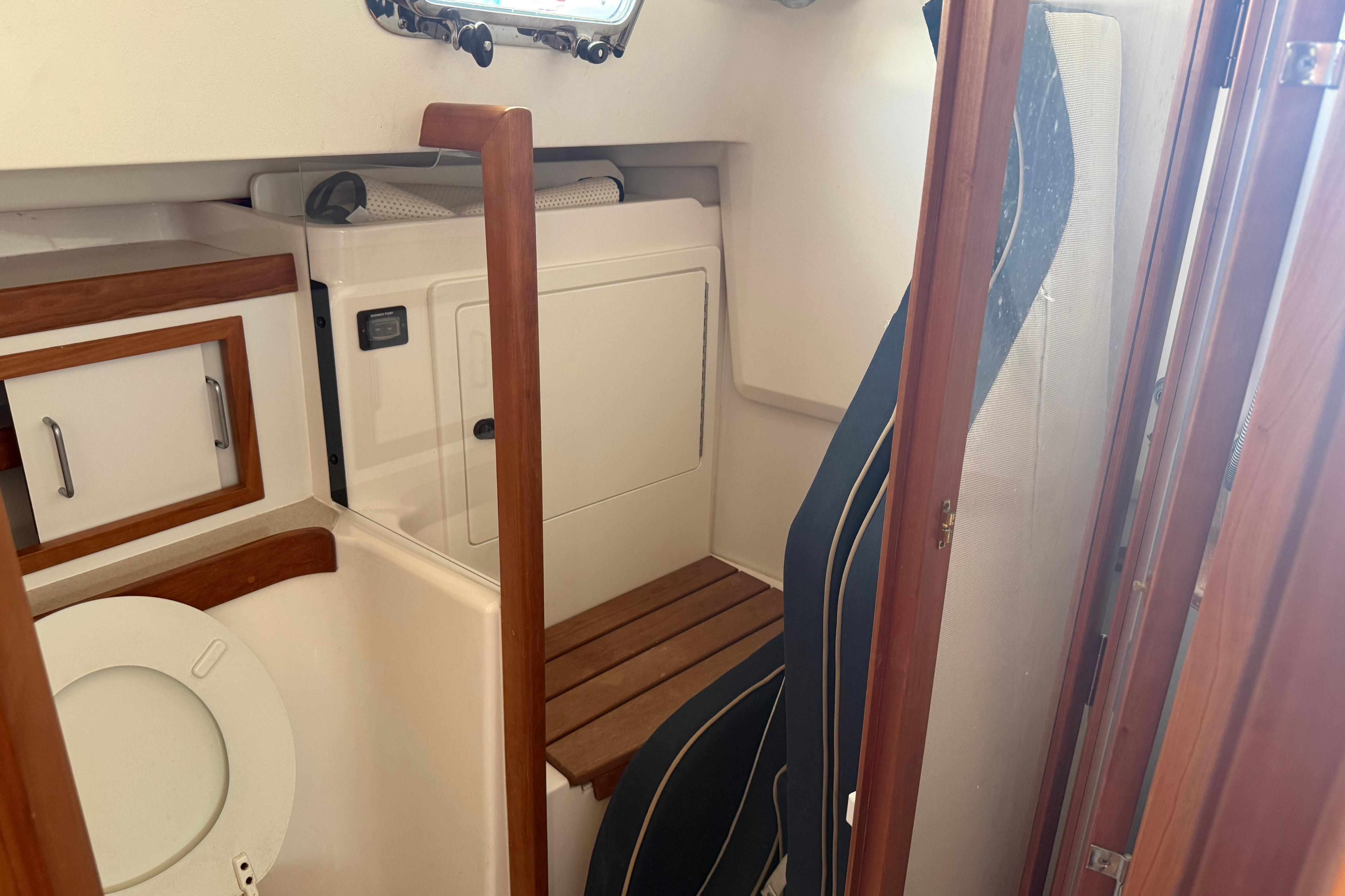 Interior of 2004 Sabre 386 sailboat bathroom with wooden accents and compact design.