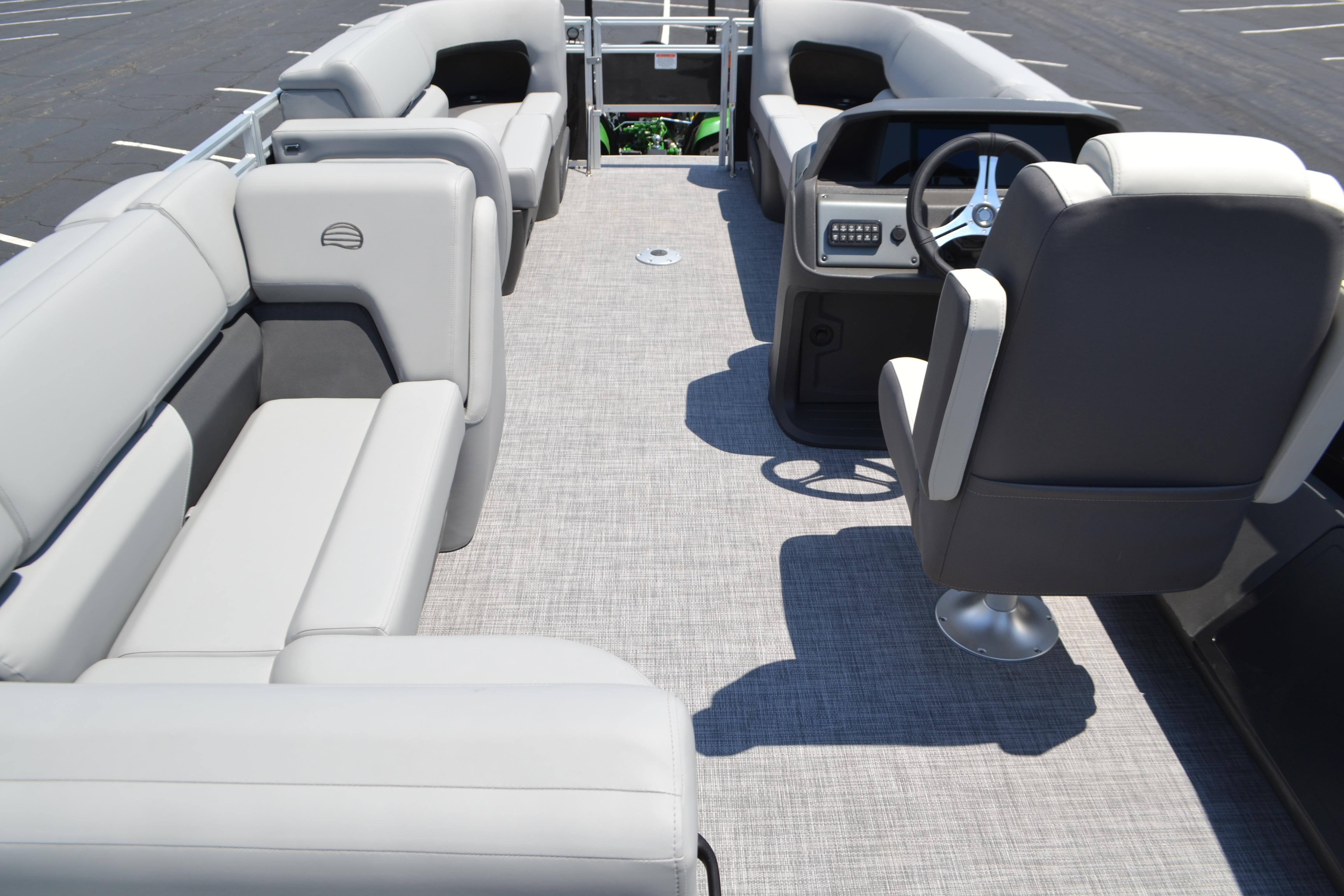 2026 Sun Tracker SportFish 22 DLX pontoon boat interior with plush seating and modern helm.