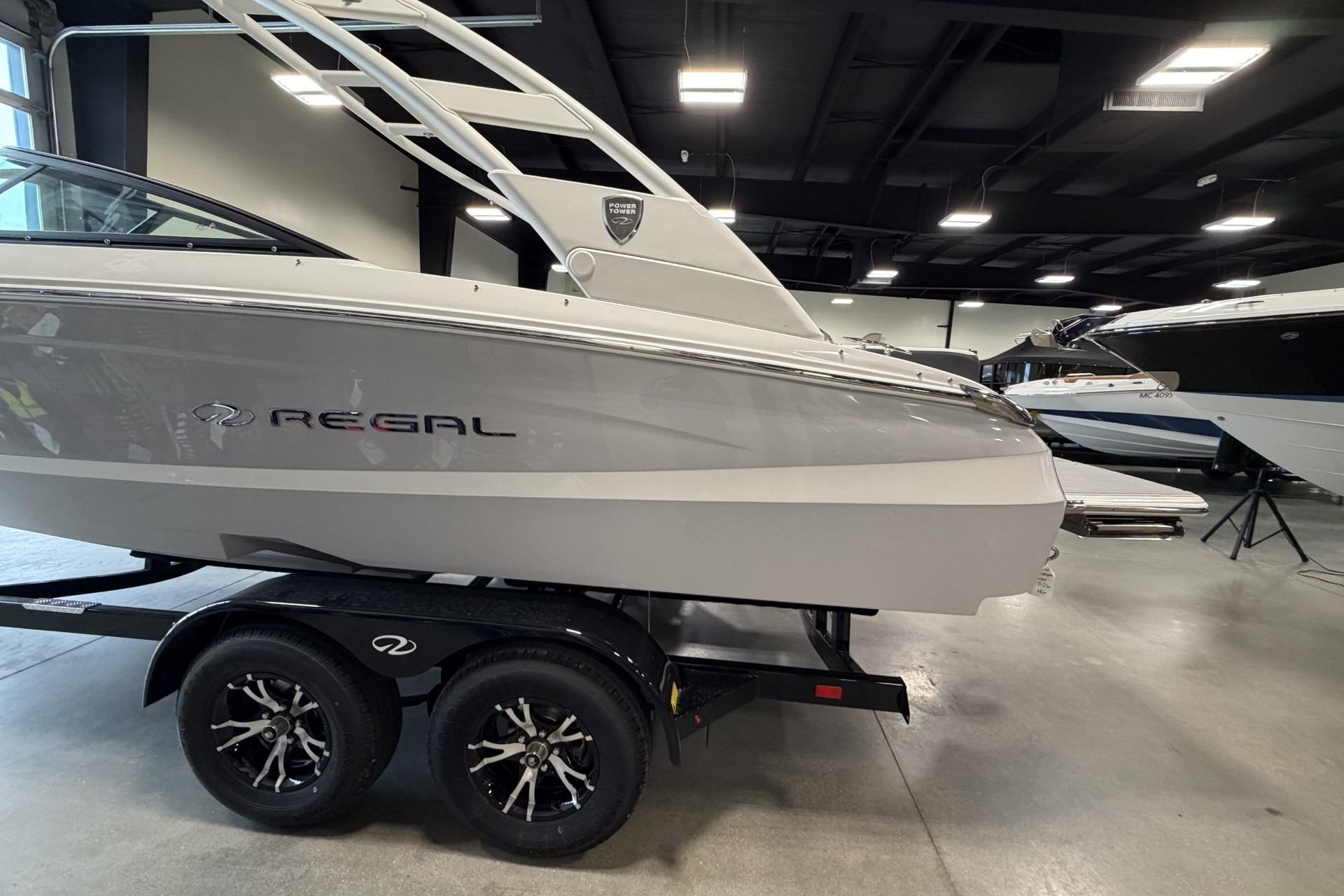 2027 Regal LS2 boat on trailer in showroom, sleek design, modern features.