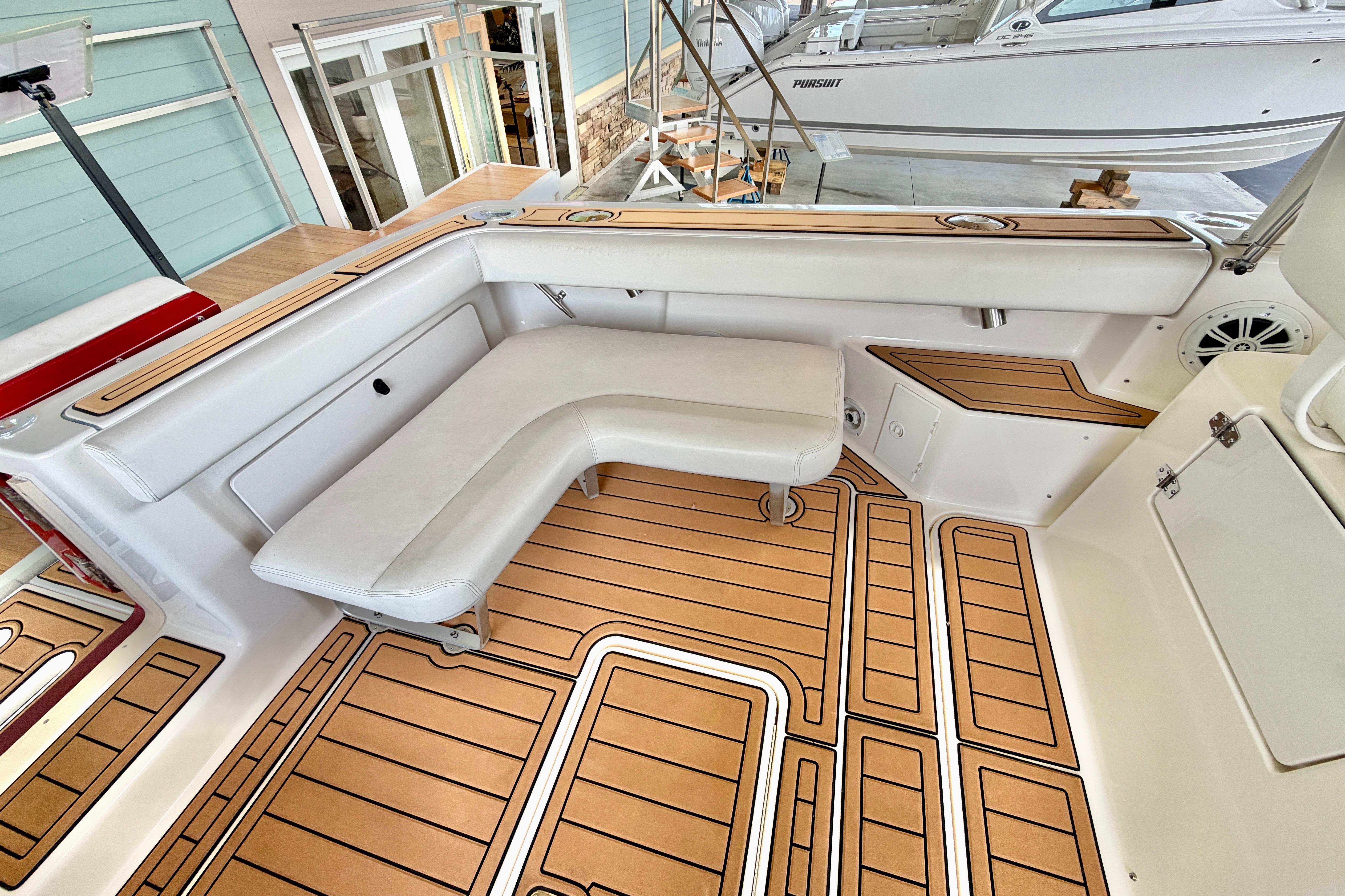 1999 Tiara Yachts 2900 Coronet interior with white seating and teak flooring.
