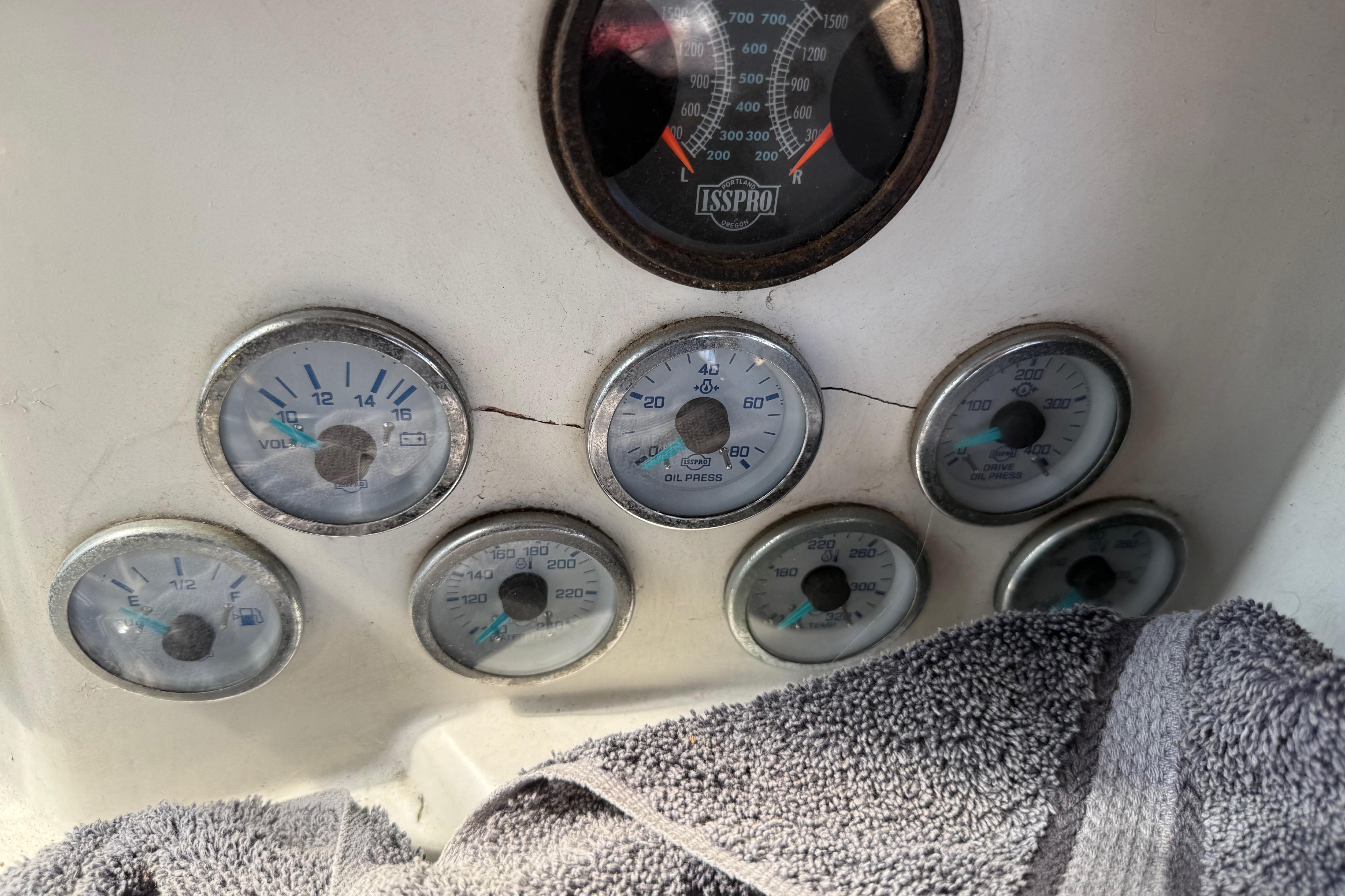 Dashboard gauges of a 1974 Pacemaker 48 Sportfisherman boat, featuring voltmeter and oil pressure indicators.