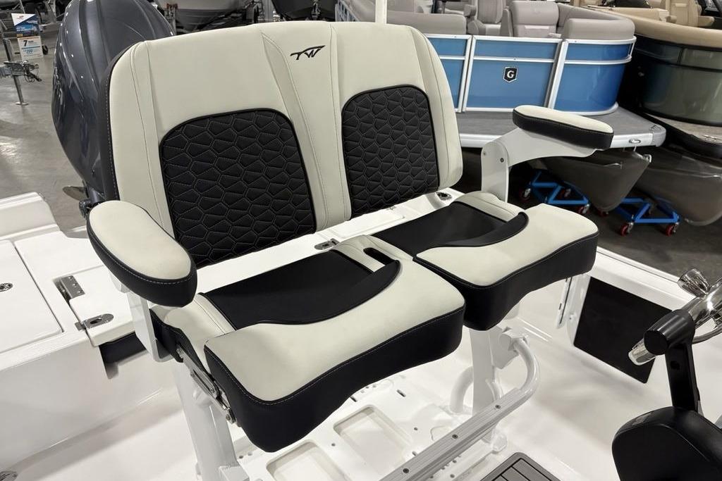 2026 Tidewater 2210 Carolina Bay boat seats with black and white upholstery in showroom.