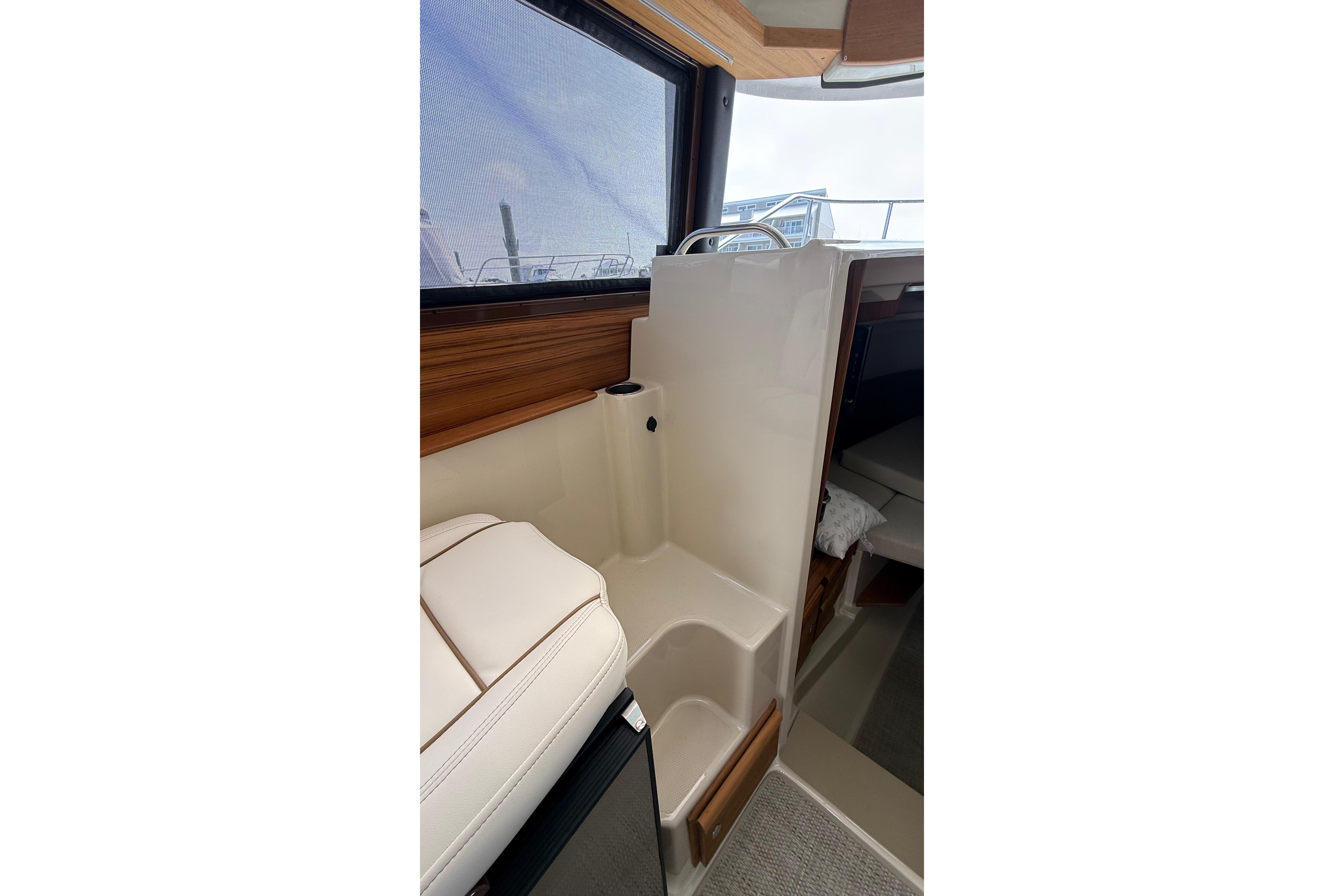2026 Ranger Tugs R-27 interior with seating and window view.