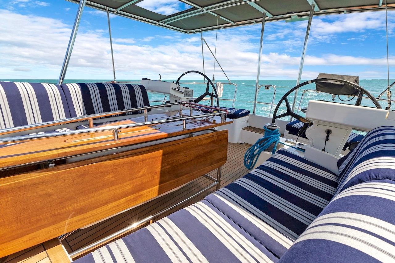 Luxurious 2011 Southerly 57 RS yacht interior with striped seating and ocean view.