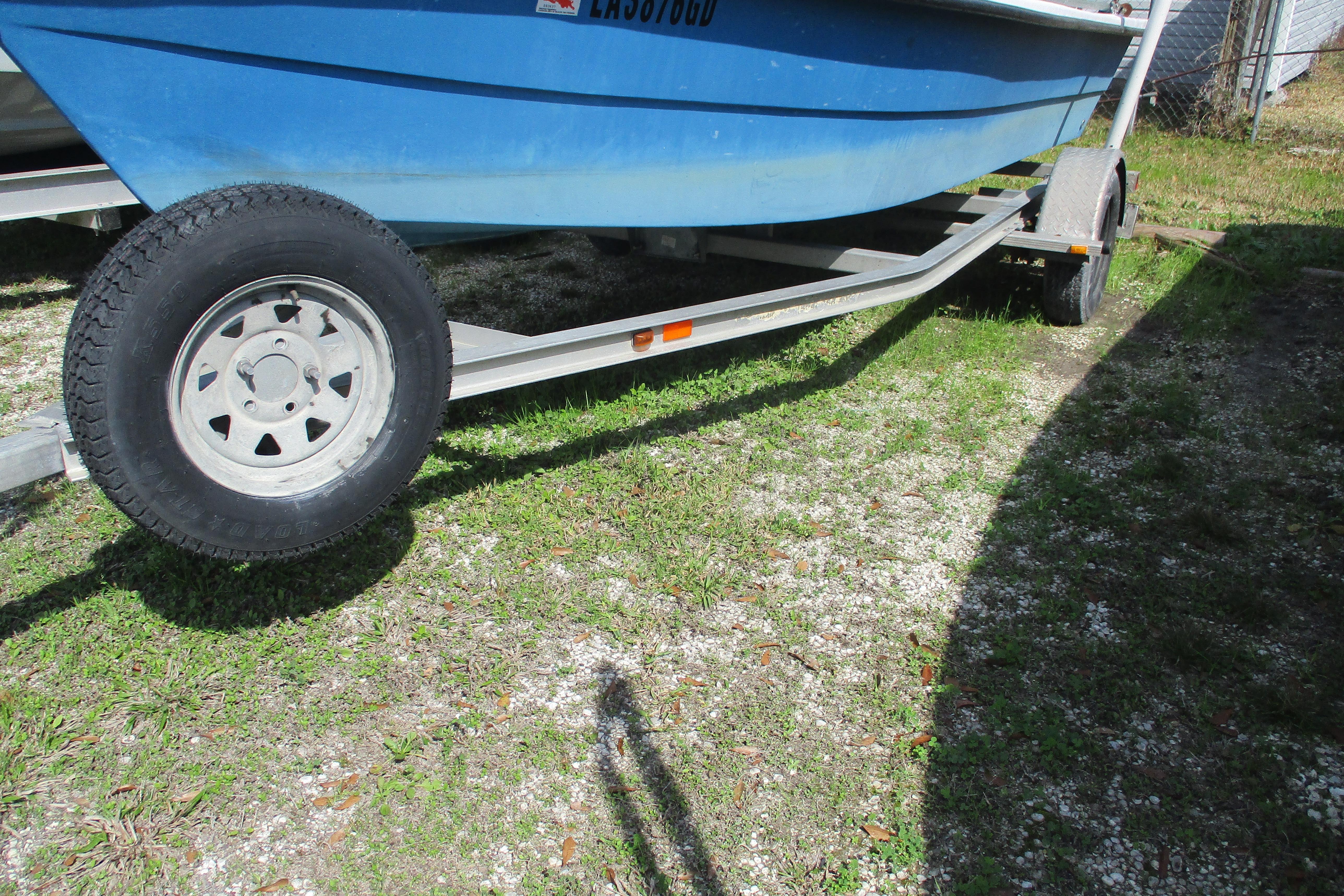 2012 Stumpknocker 17 SPORT boat on trailer, parked on grassy area.